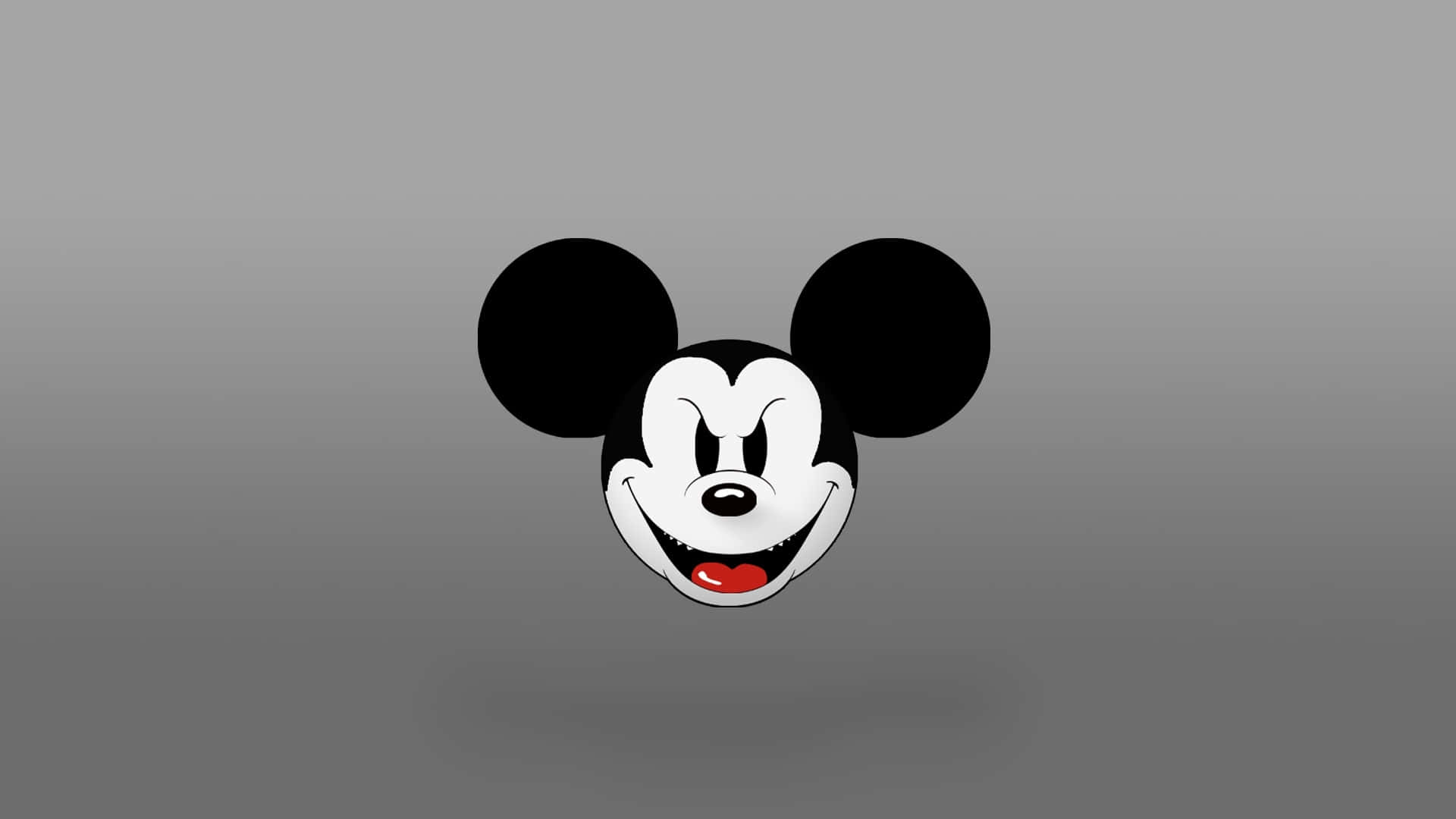 Mickey Mouse Desktop 桌布 壁紙 — 經典米奇老鼠頭部，有大黑耳朵和紅唇，在灰色漸變背景上微笑。