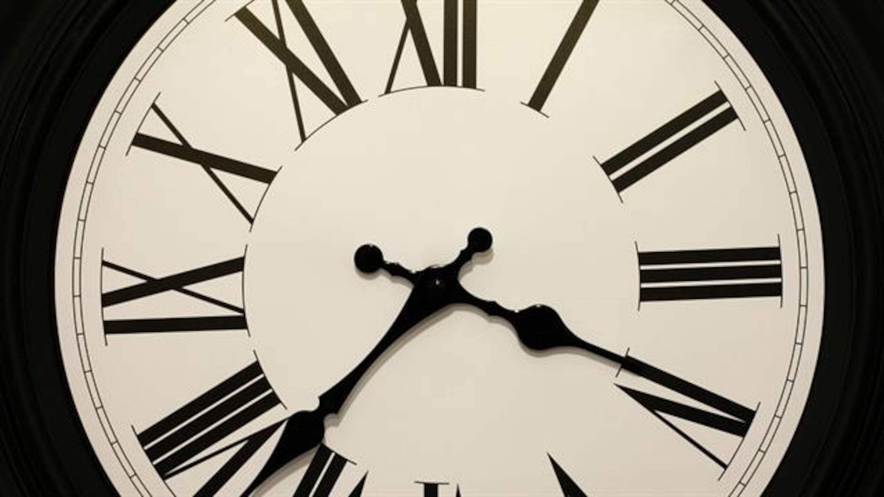 Clock 桌布 壁紙 — 經典類比時鐘錶盤的特寫，帶有黑色羅馬數字和指針，背景為白色。