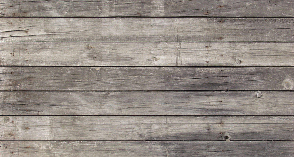 Wood Texture 桌布 壁紙 — 經過風化的灰色木板，帶有可見的木紋節和自然紋理，形成質樸的水平圖案。