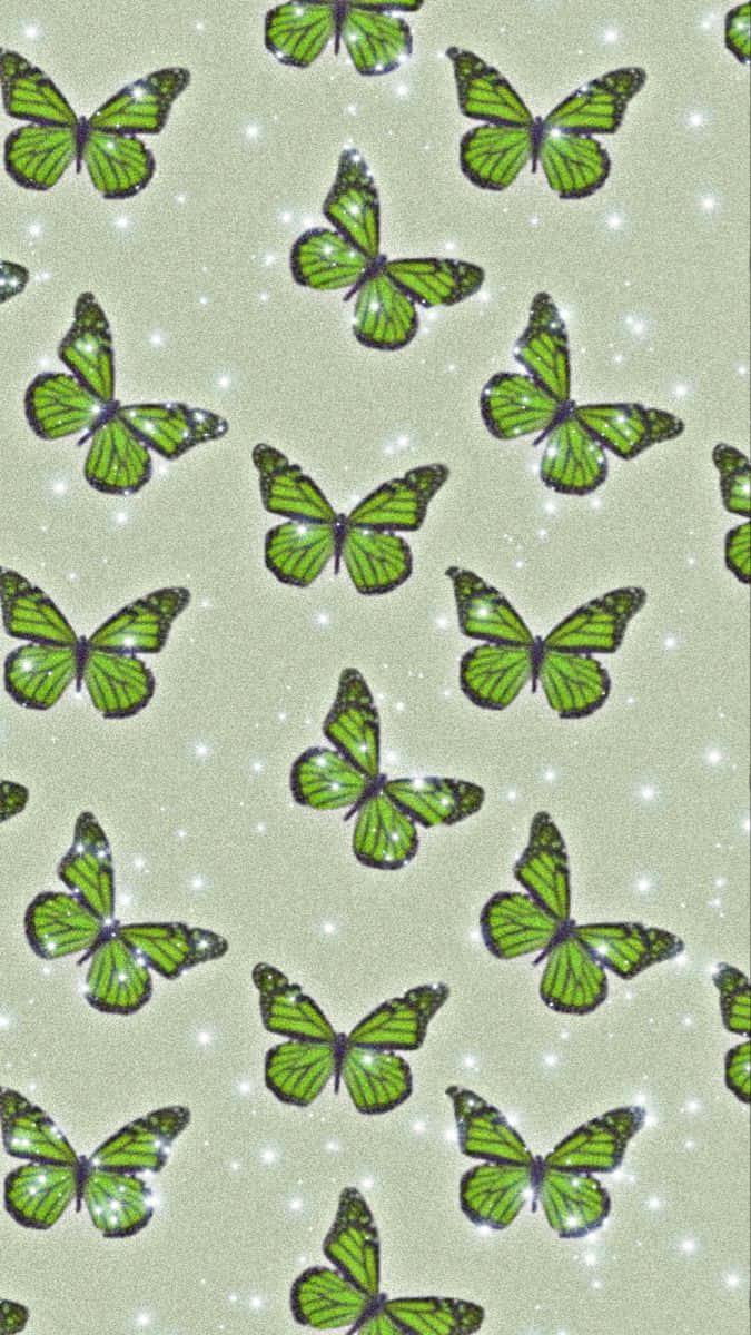 Green Butterfly 桌布 壁紙 — 綠色蝴蝶閃爍翅膀漂浮在柔軟灰色背景上，點綴著白色閃光。