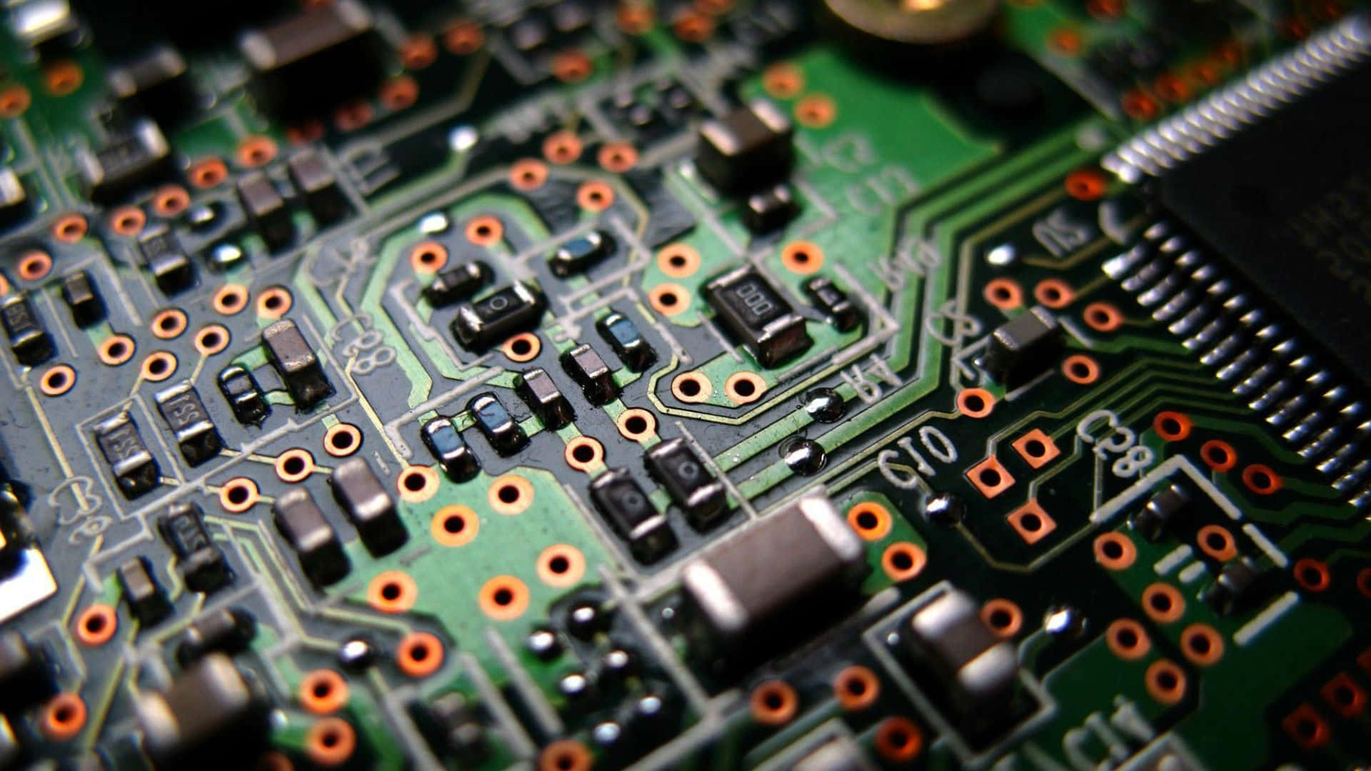Electronics 桌布 壁紙 — 綠色電路板的特寫微距，帶有複雜的銅線路和橙色焊盤。
