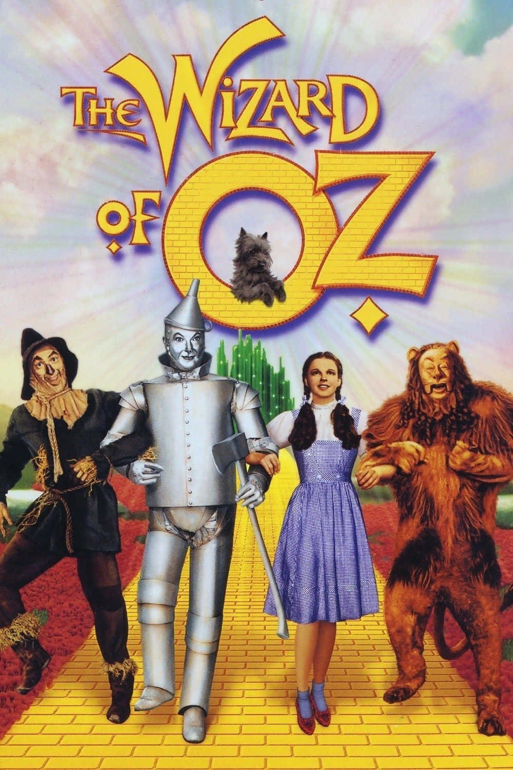 wizard of oz 桌布 壁紙 — 《綠野仙蹤》中的四個標誌性角色站在黃磚路上，天空色彩繽紛，上方有標題標誌。