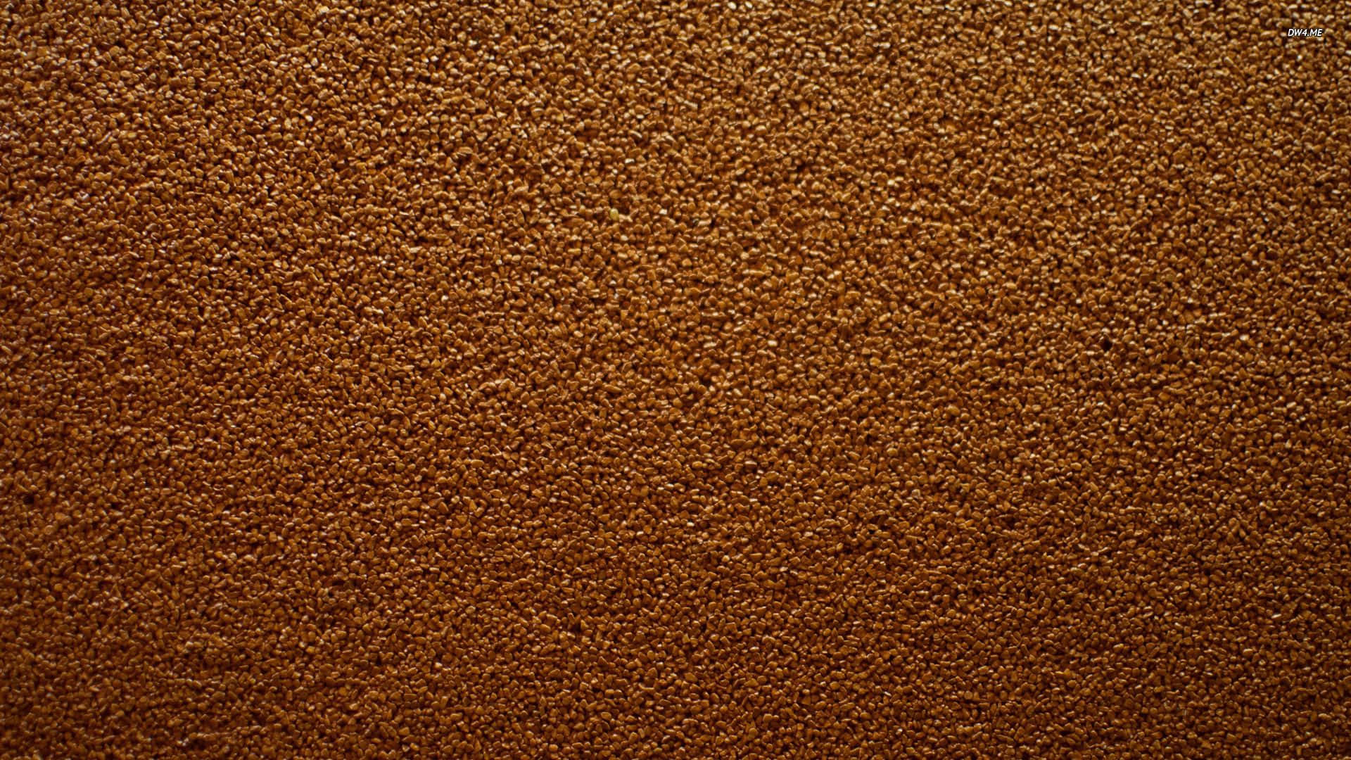 Brown 桌布 壁紙 — 緊密棕色顆粒質感的特寫，類似咖啡渣或土壤，帶有豐富的大地色調。