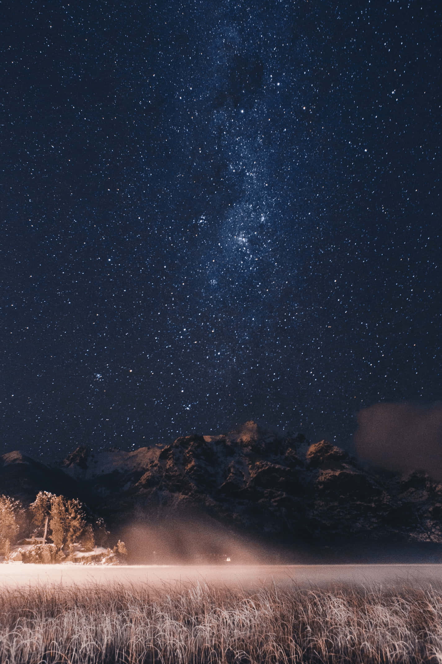 Starry 桌布 壁紙 — 繁星點點的夜空，銀河拱跨在積雪的山峰和霜凍的田野之上。