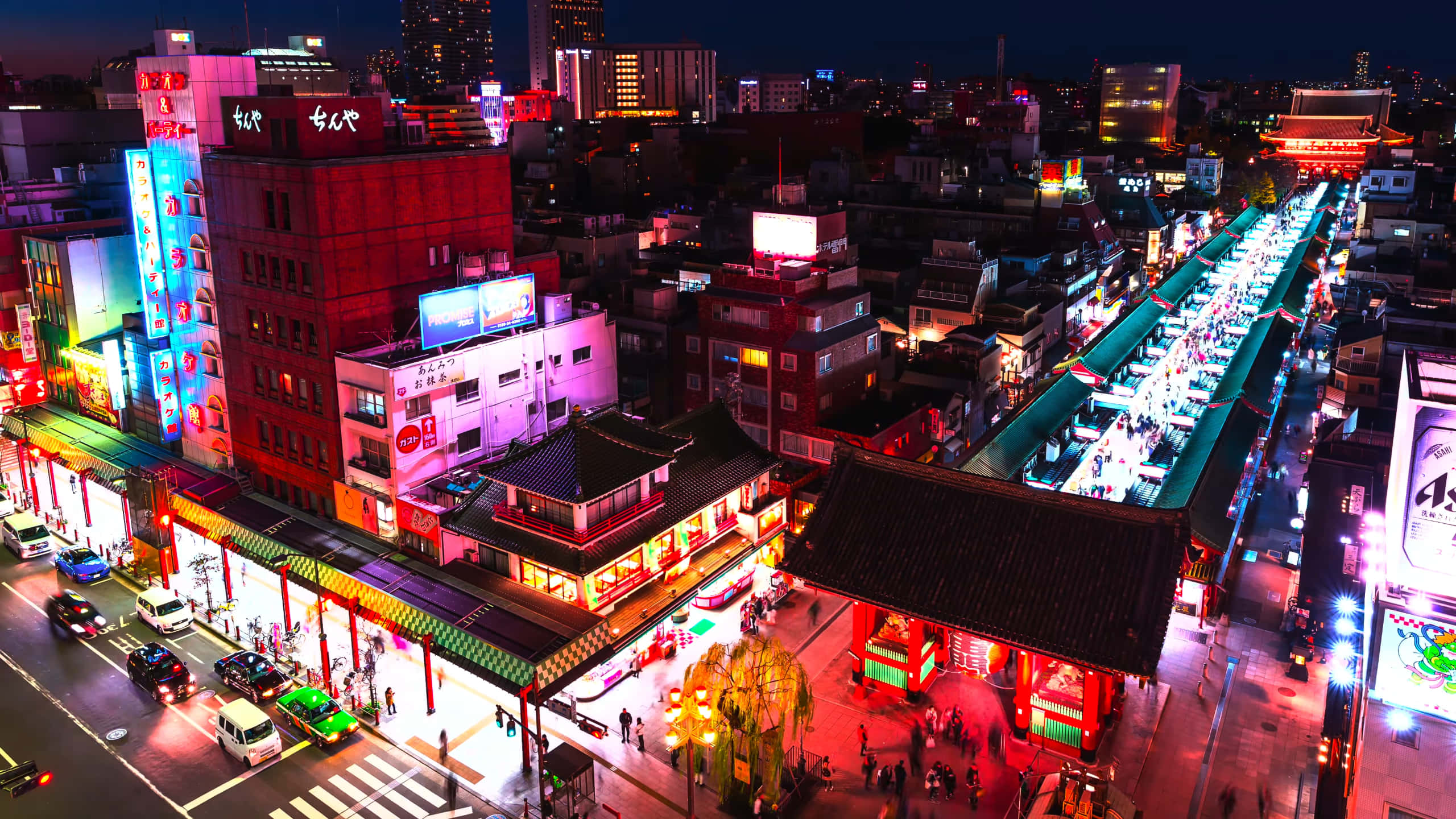 Harajuku 桌布 壁紙 — 繁華的日本城市街道夜景鳥瞰圖，霓虹燈閃爍，人群熙攘，招牌發光。