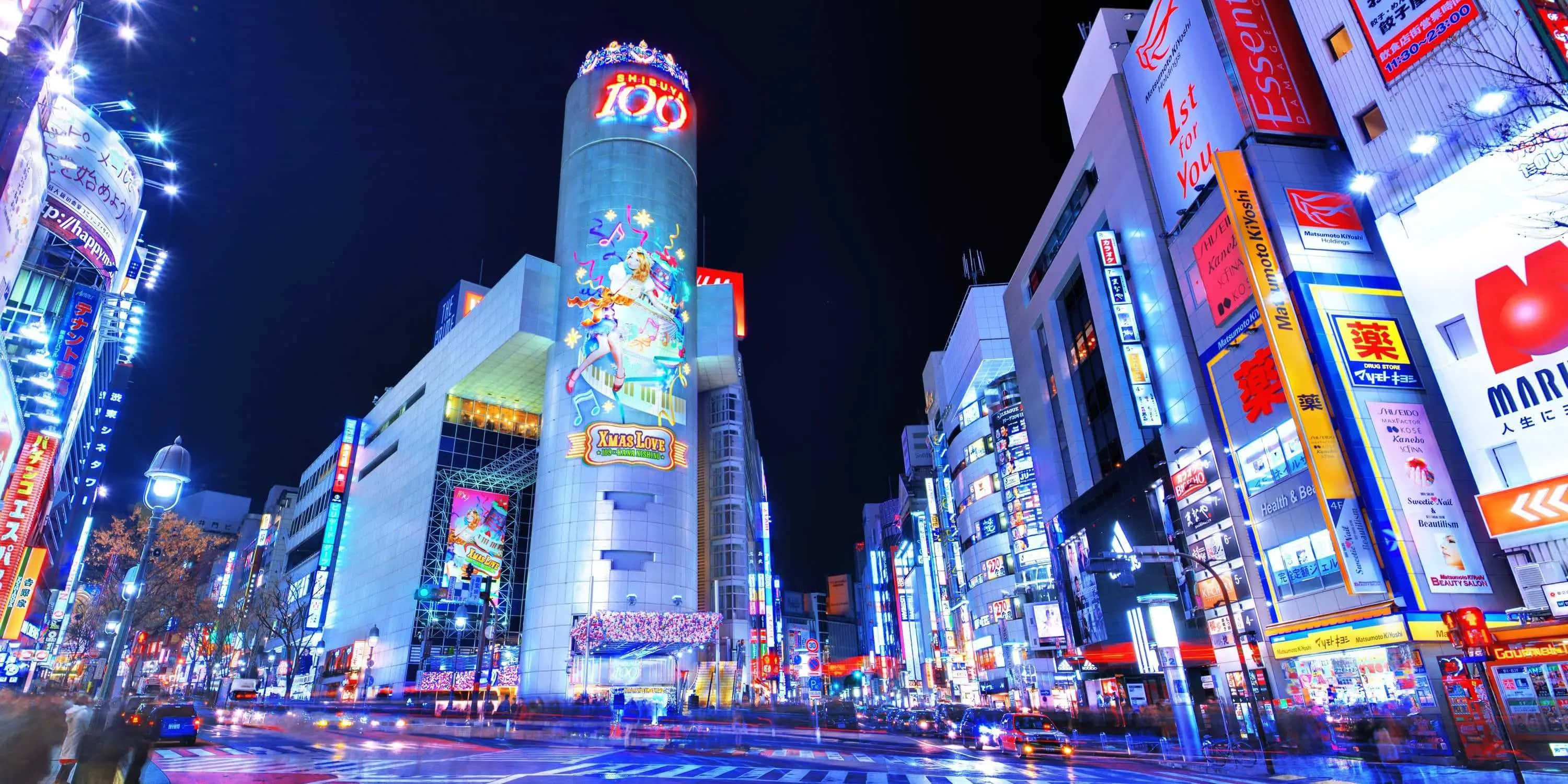 東京 桌布 壁紙 — 繁華都市區中霓虹燈閃爍的摩天大樓和發光廣告牌的耀眼夜景。