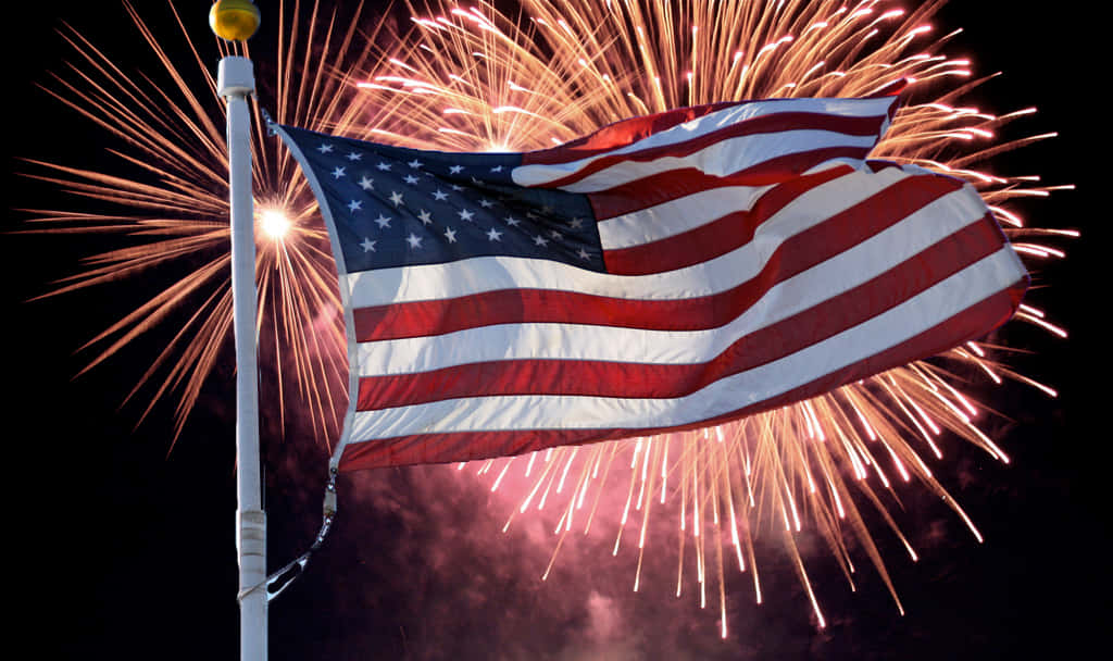 Happy Fourth Of July 桌布 壁紙 — 美國國旗在充滿活力金色煙火爆發的夜空中自豪地飄揚。
