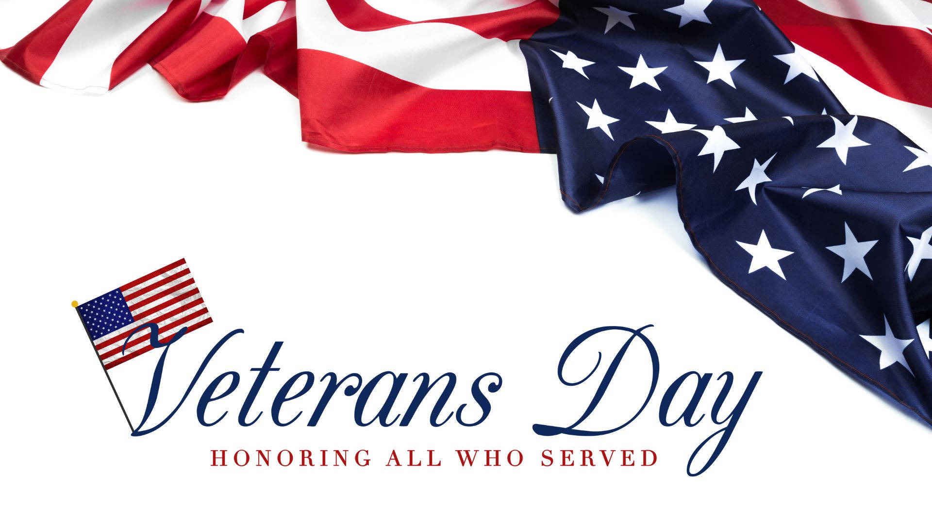 Flag 桌布 壁紙 — 美國國旗斜掛在白色背景上，帶有優雅的「Veterans Day」字體和下方的小國旗圖標。