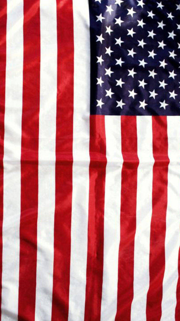 American Flag iPhone 桌布 壁紙 — 美國國旗特寫，紅白條紋和藍色區域上有白色星星，顯示布料質地和摺痕。