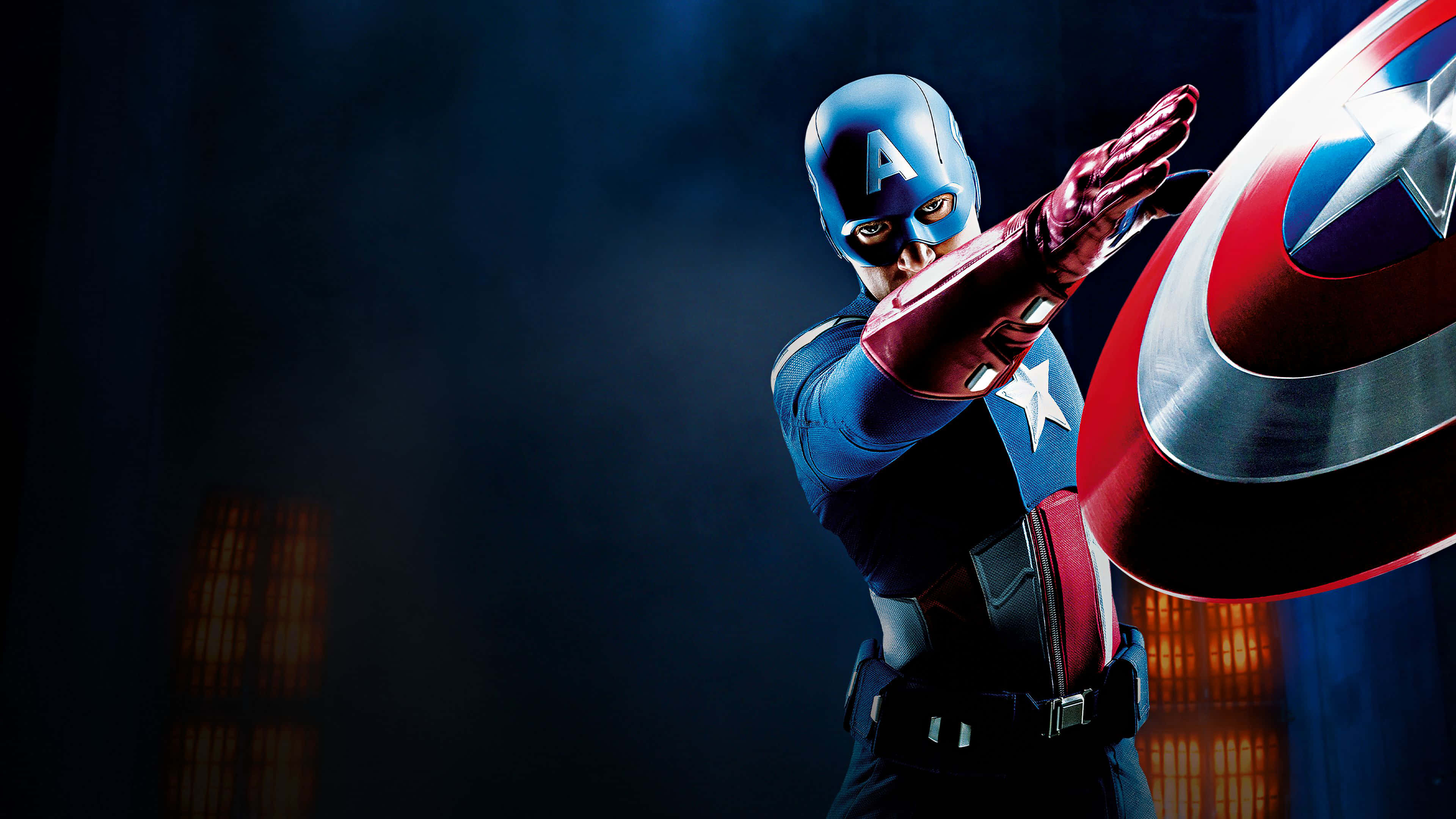 4K Captain America 桌布 壁紙 — 美國隊長以戲劇性的姿勢手持標誌性盾牌，背景是黑暗煙霧繚繞，帶有溫暖發光的窗戶。