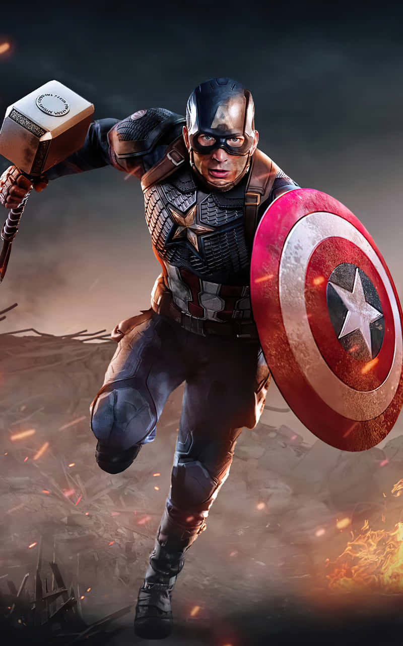 Captain America Android 桌布 壁紙 — 美國隊長在戰鬥中向前衝鋒，揮舞著雷神之鎚和他標誌性的盾牌，周圍是燃燒的碎片和煙霧。
