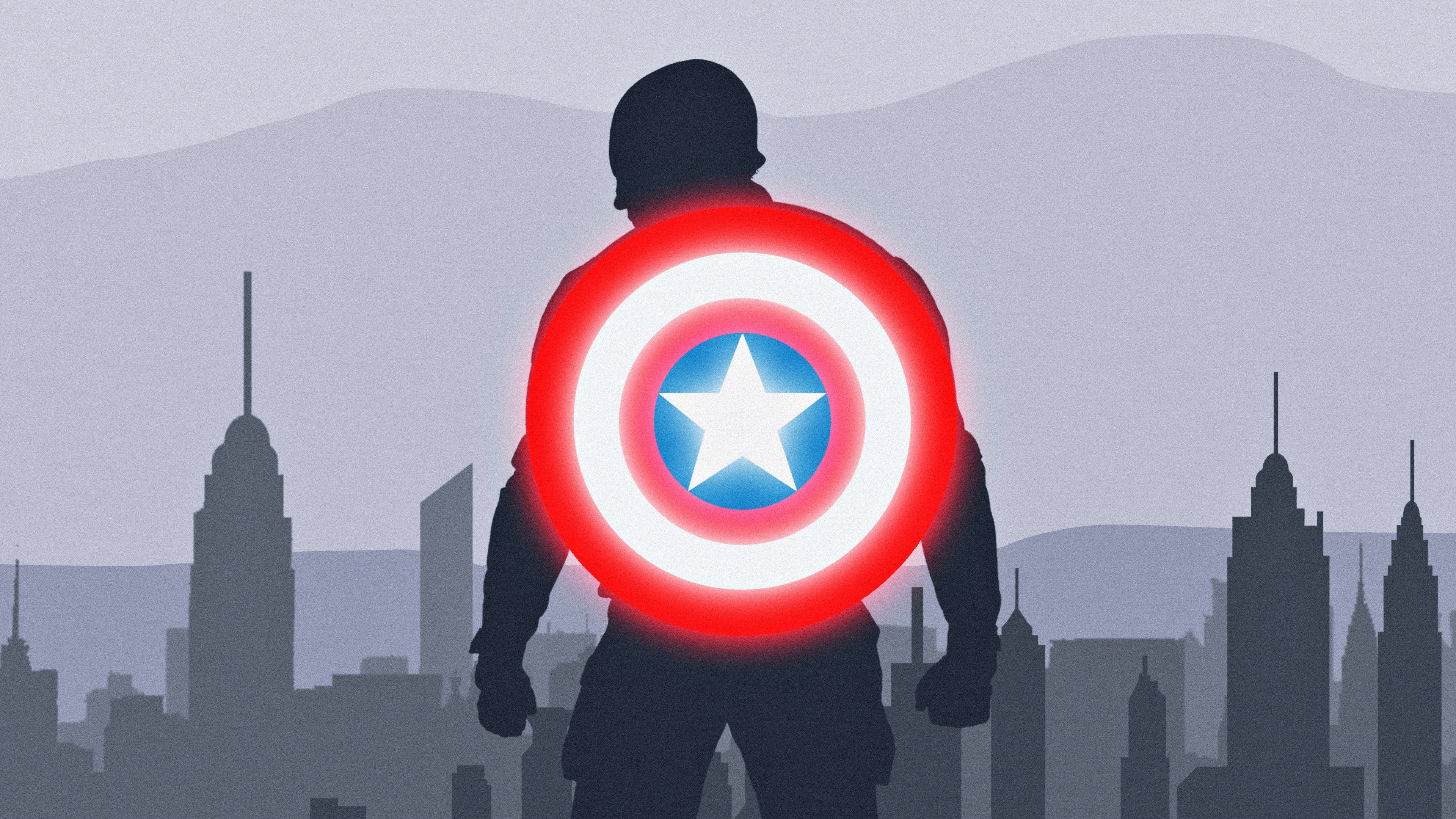 Marvel Aesthetic 桌布 壁紙 — 美國隊長手持發光盾牌，面向城市天際線，背景有山脈的剪影。