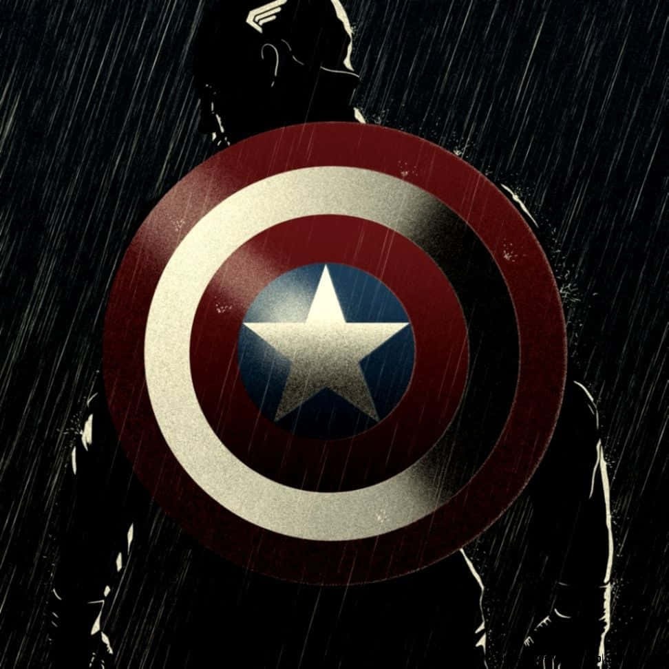 Captain America Logo 桌布 壁紙 — 美國隊長的剪影在黑暗的雨景中，手持其標誌性盾牌，雨水如絲般落下。