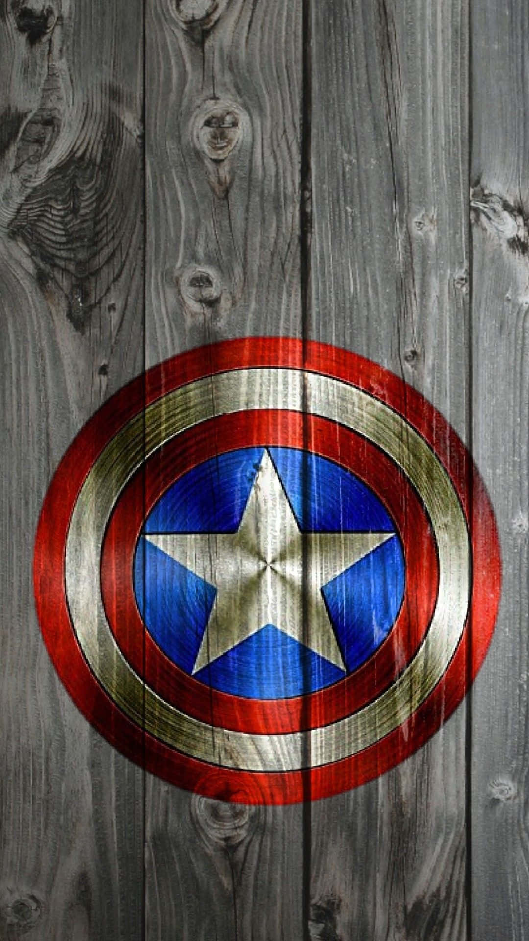 Android Captain America 桌布 壁紙 — 美國隊長的標誌性盾牌放在風化灰色木板上，木紋和節疤清晰可見。
