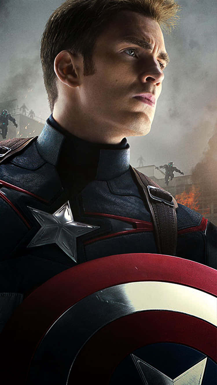 Captain America Android 桌布 壁紙 — 美國隊長身穿戰鬥裝備，手持標誌性盾牌，在煙霧瀰漫的戰爭廢墟背景下堅定站立。