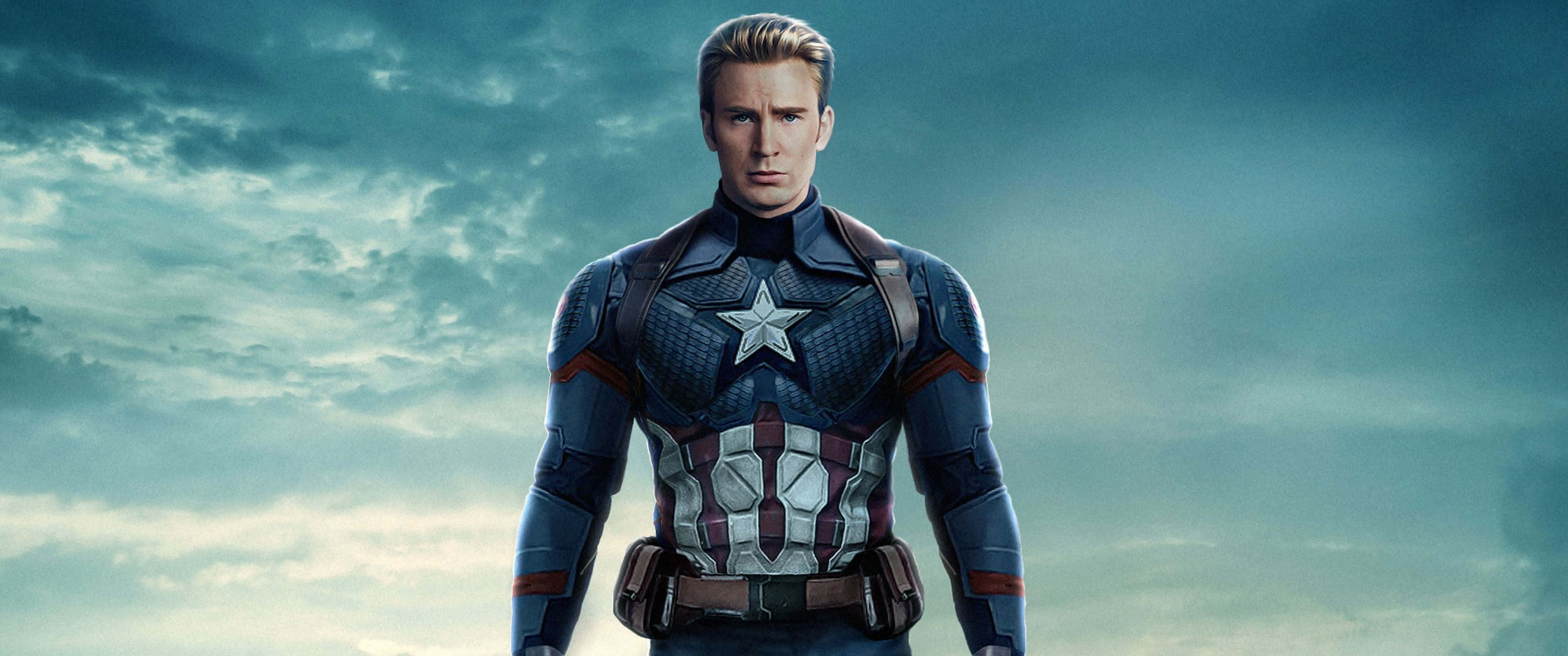 Marvel Movie 桌布 壁紙 — 美國隊長身穿標誌性的星形徽章戰衣，在陰沉多雲的天空下堅定地站立。