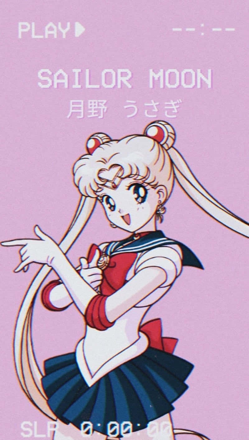美少女戰士 桌布 壁紙 — 美少女戰士動畫角色穿著水手服，在柔和的粉紅色背景前頑皮地指著，帶有遊戲介面文字。