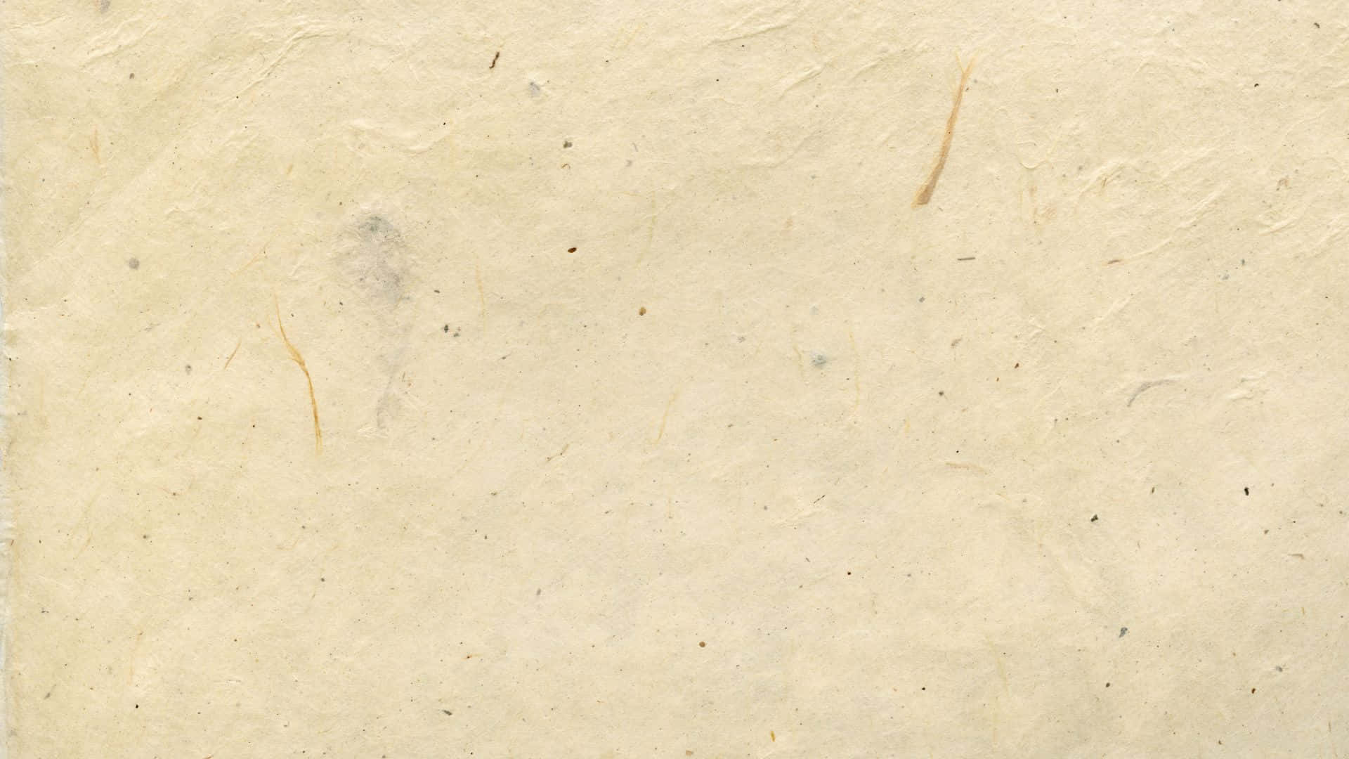 Old Paper Texture 桌布 壁紙 — 老化的奶油色手工紙的特寫，有可見的纖維和微妙的污漬。