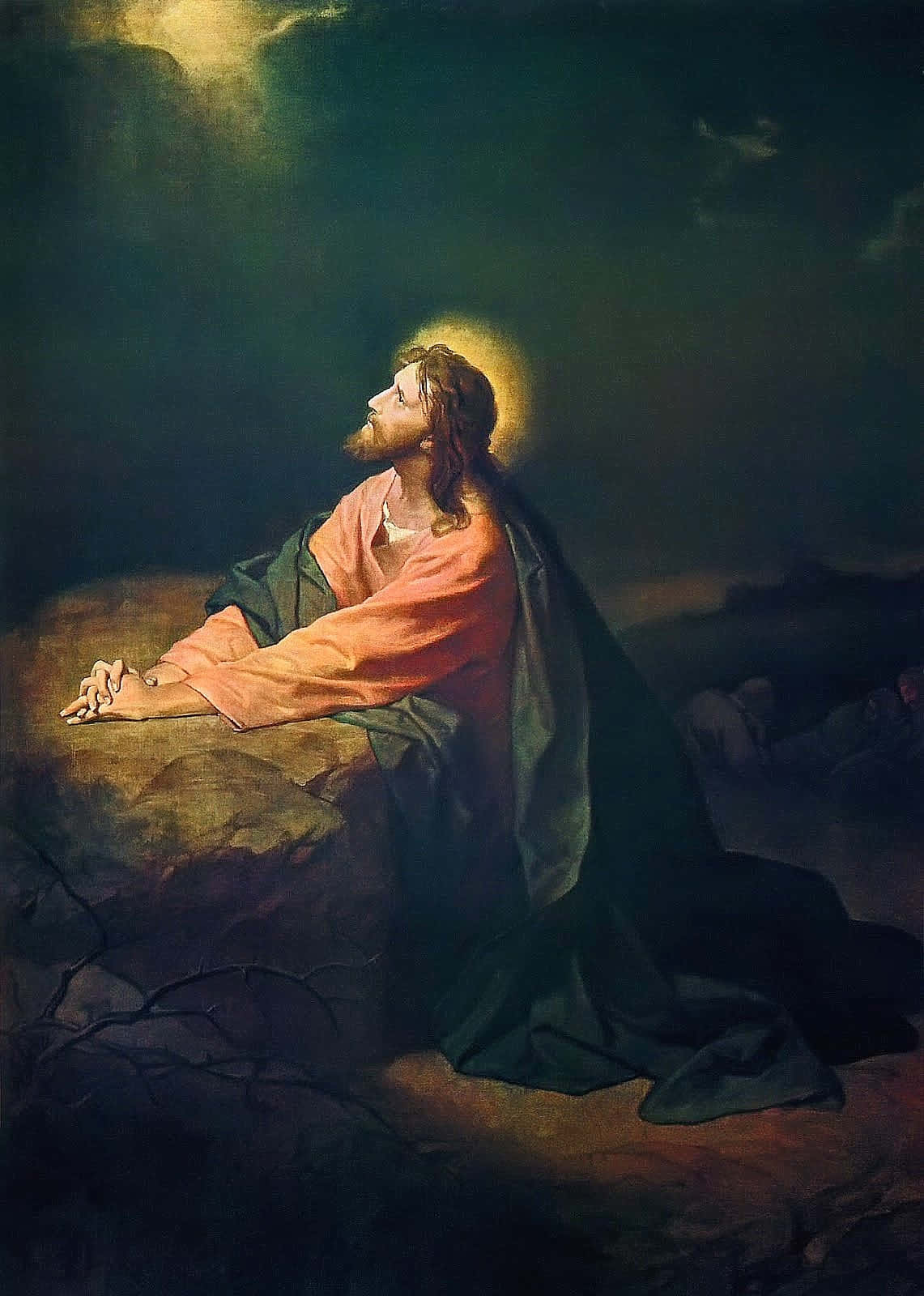 Jesus Praying 桌布 壁紙 — 耶穌在岩石山坡上跪下祈禱，天空戲劇性，神聖的光芒照亮祂的身影。