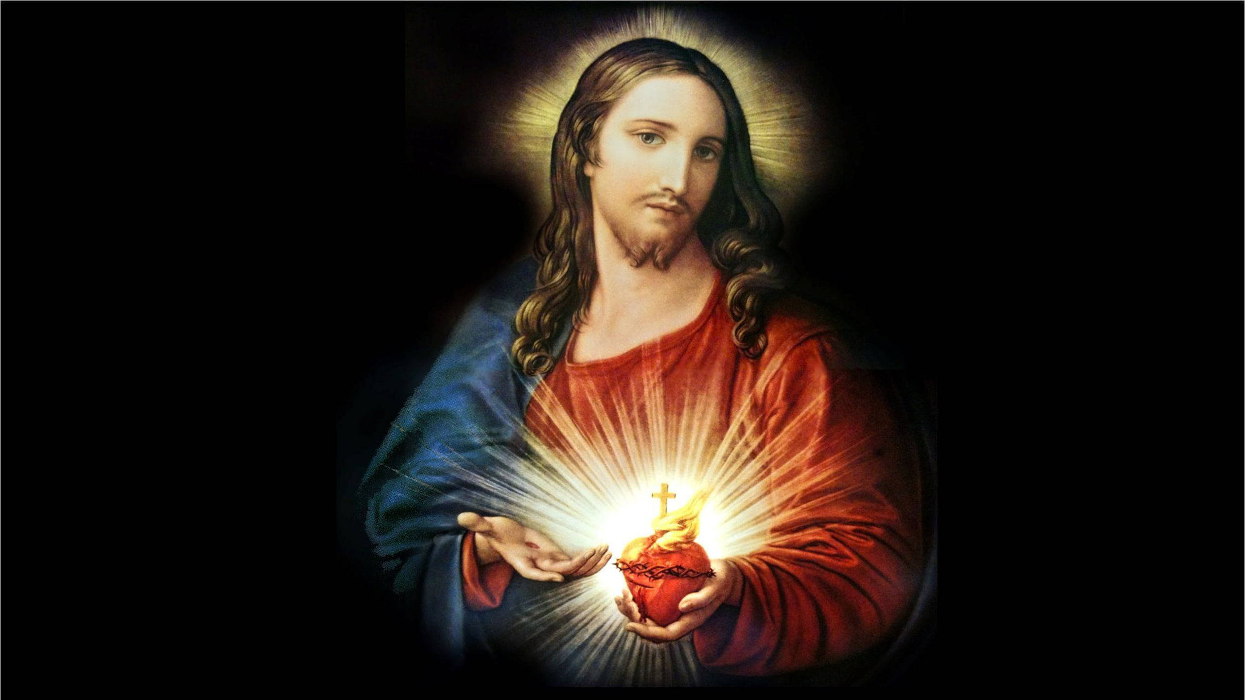 Christ 桌布 壁紙 — 耶穌基督在黑暗背景中手持發光的聖心，散發光芒。