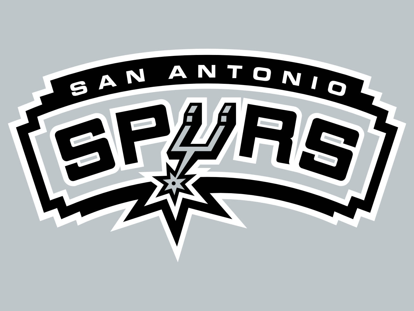 Spurs 桌布 壁紙 — 聖安東尼奧馬刺隊標誌，大膽黑白配色，帶有星爆設計，淺灰色背景。