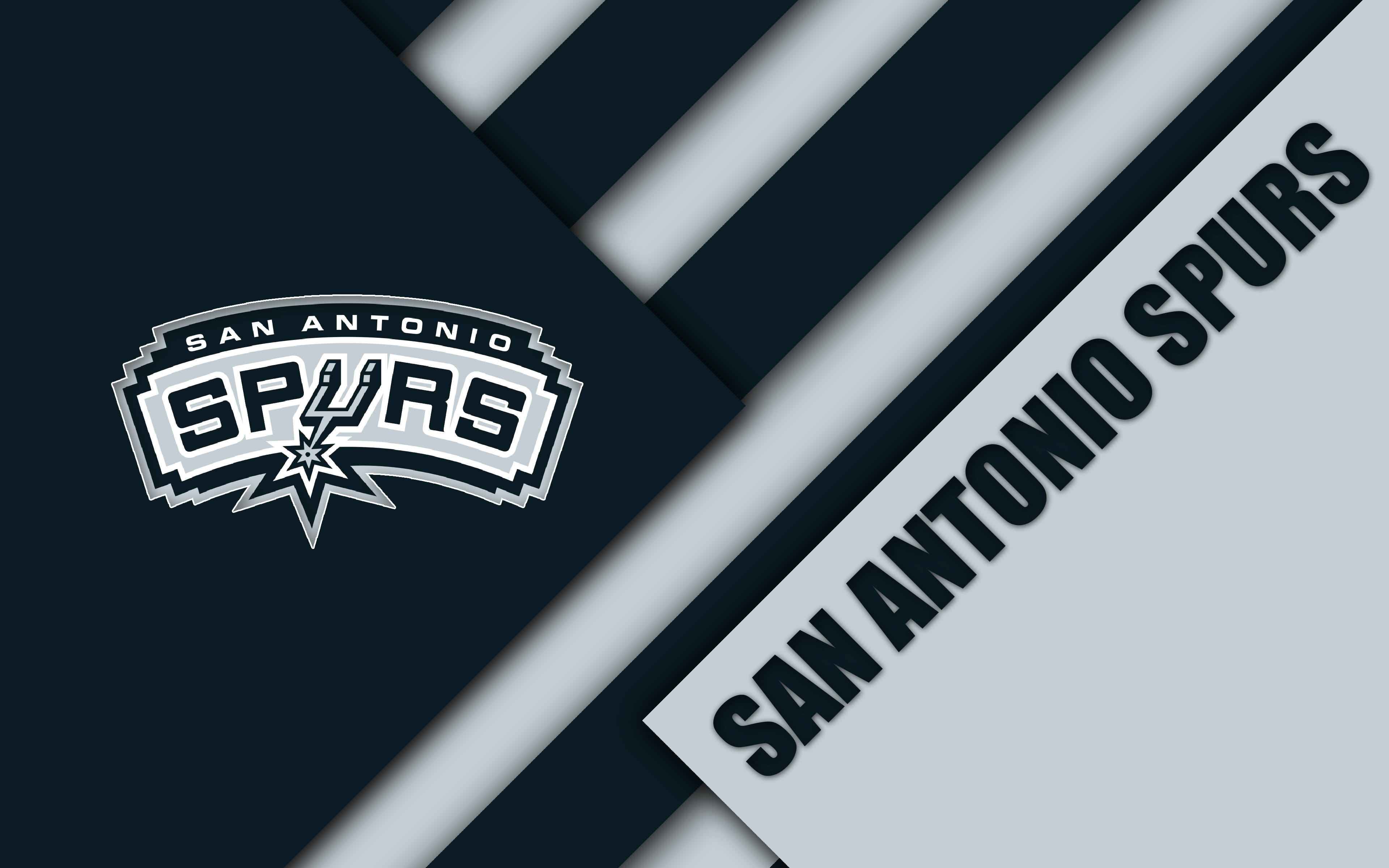 Spurs 桌布 壁紙 — 聖安東尼奧馬刺隊標誌以白色和黑色呈現，背景為幾何海軍藍和灰色條紋。