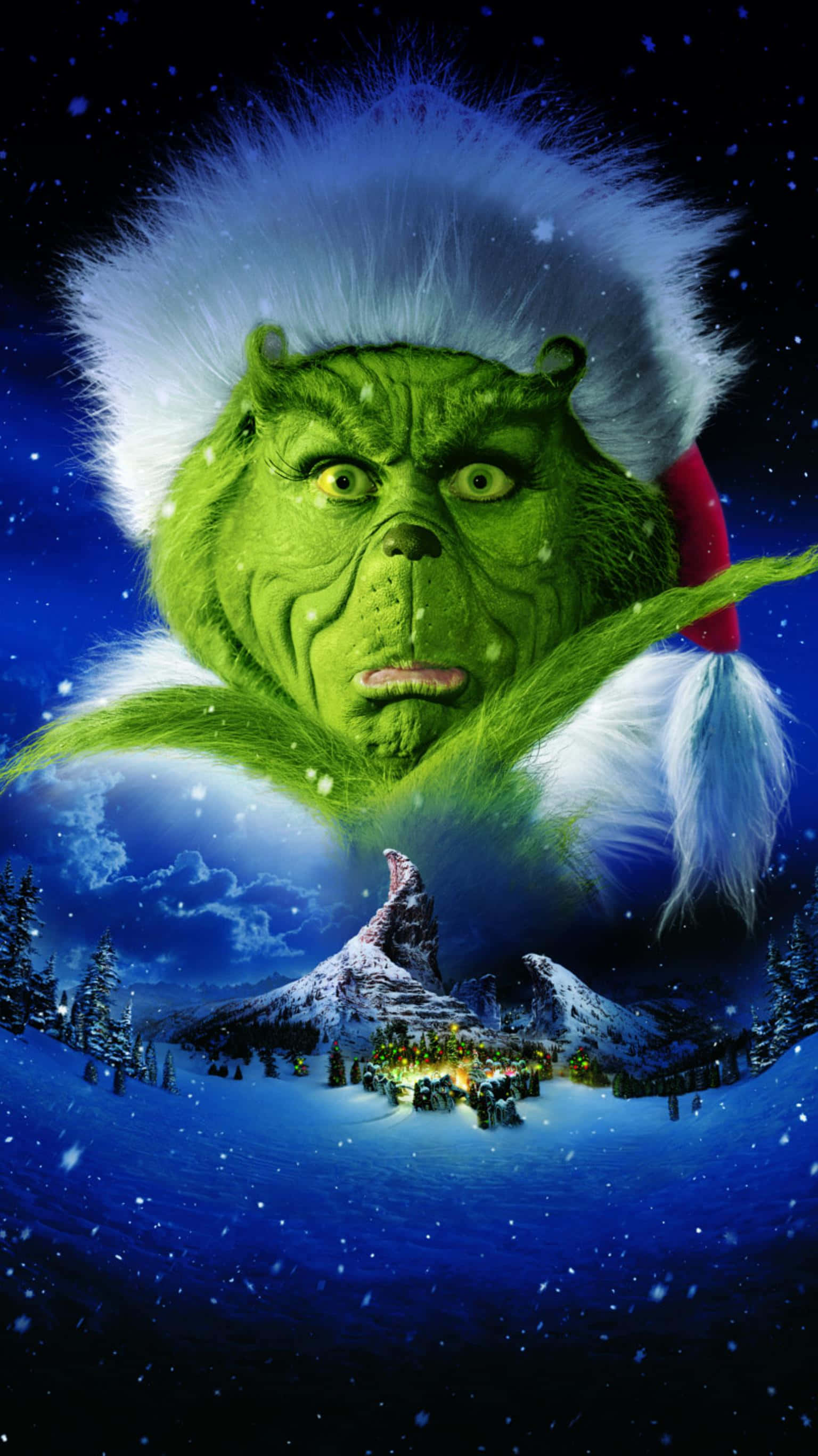 鬼靈精 桌布 壁紙 — 聖誕帽的鬼靈精從白雪覆蓋的山頂怒視著星空下節日村莊。