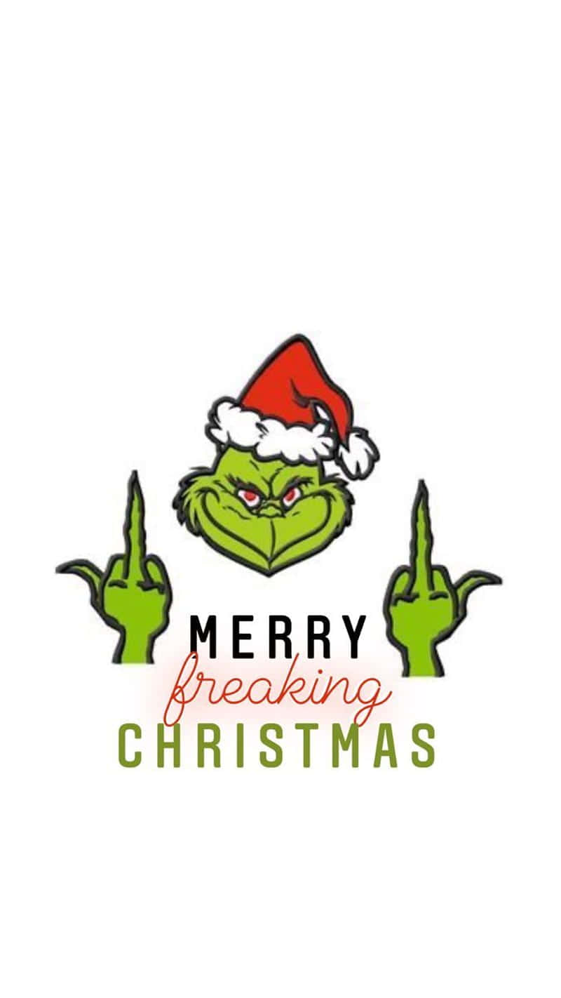 桌布 壁紙 — 聖誕怪傑戴著紅色聖誕帽，雙手向觀眾比中指，下方有文字「Merry freaking Christmas」。
