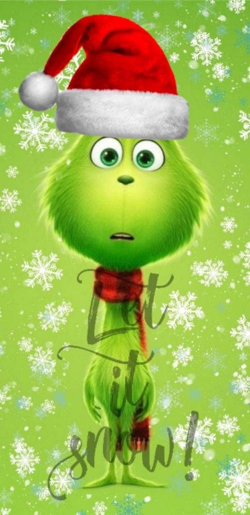 鬼靈精 桌布 壁紙 — 聖誕怪傑戴著紅色聖誕帽和圍巾，站在綠色雪景背景前，上面有「Let it snow!」文字。