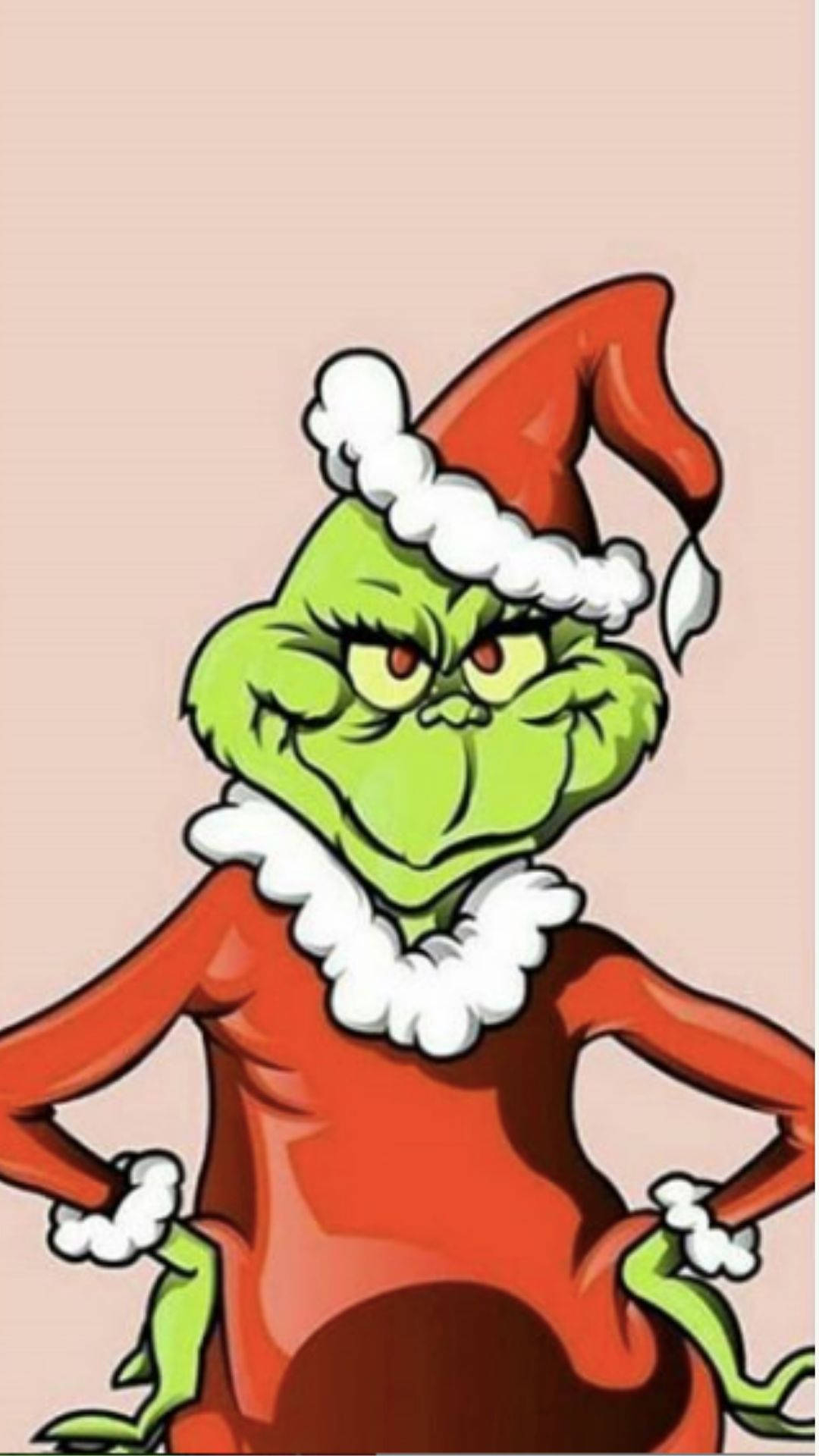 Kawaii Christmas 桌布 壁紙 — 聖誕怪傑穿著紅色聖誕老人服裝，帶白色飾邊和帽子，雙手叉腰站在淡粉色背景前。