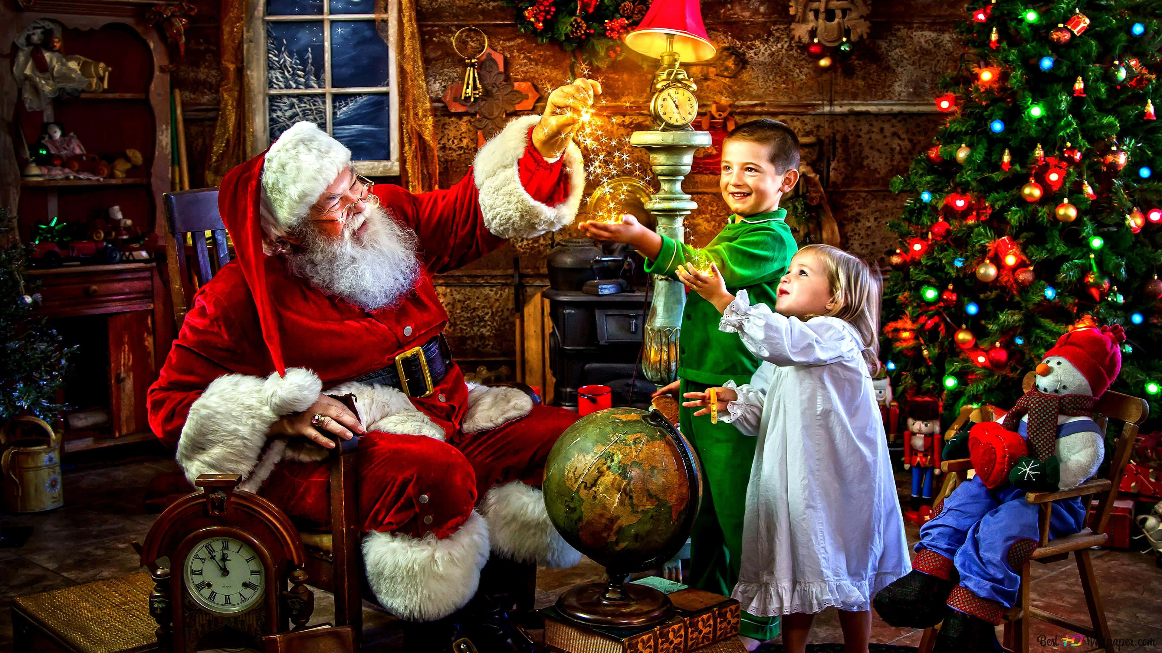 Santa Claus 桌布 壁紙 — 聖誕老人在舒適的小屋中，與兩個微笑的孩子分享魔法，他們觸摸著裝飾聖誕樹旁邊的燈所發出的發光星星。