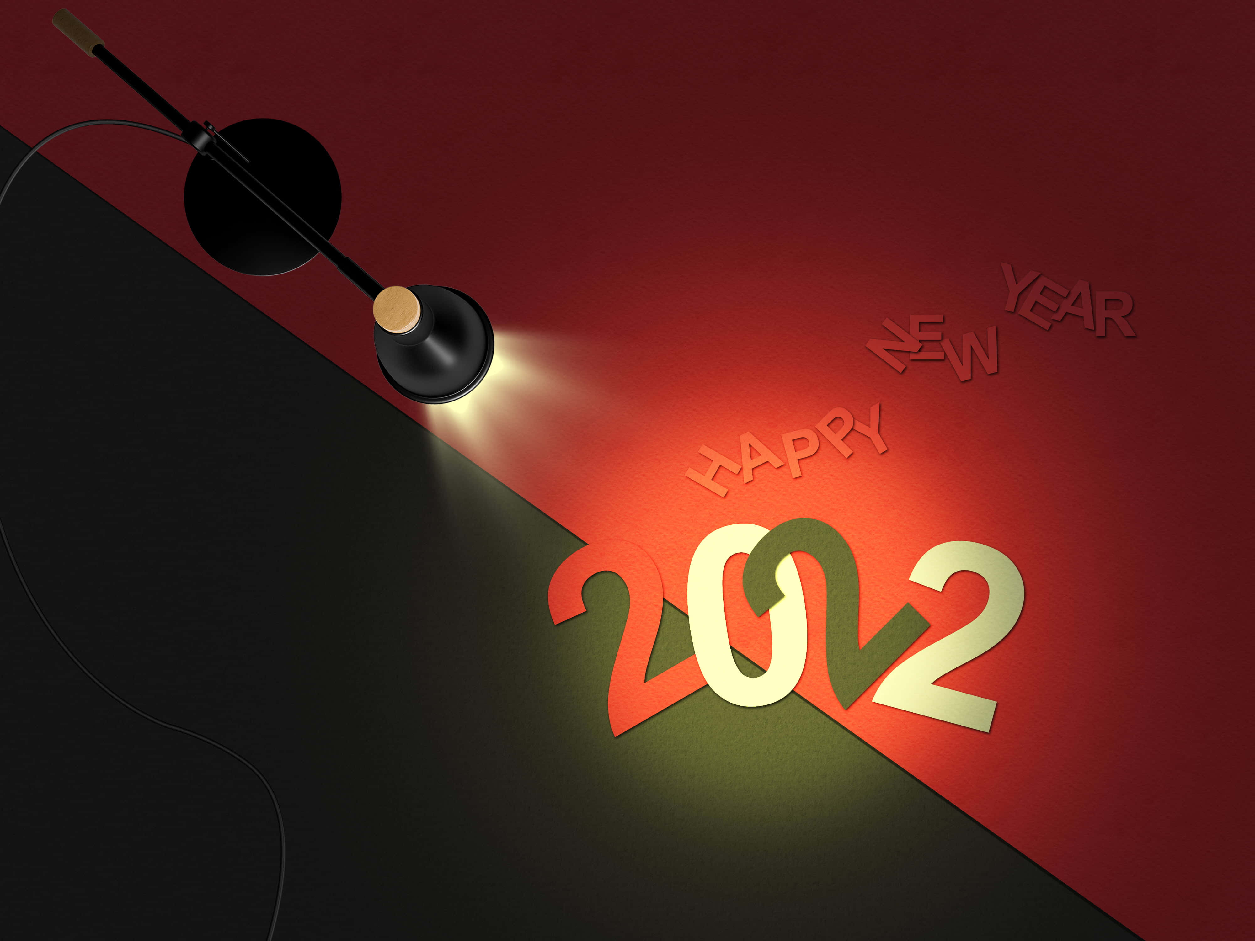 Happy New Year 2022 桌布 壁紙 — 聚光燈照亮了在紅黑分區牆上的粗體2022和Happy New Year文字。