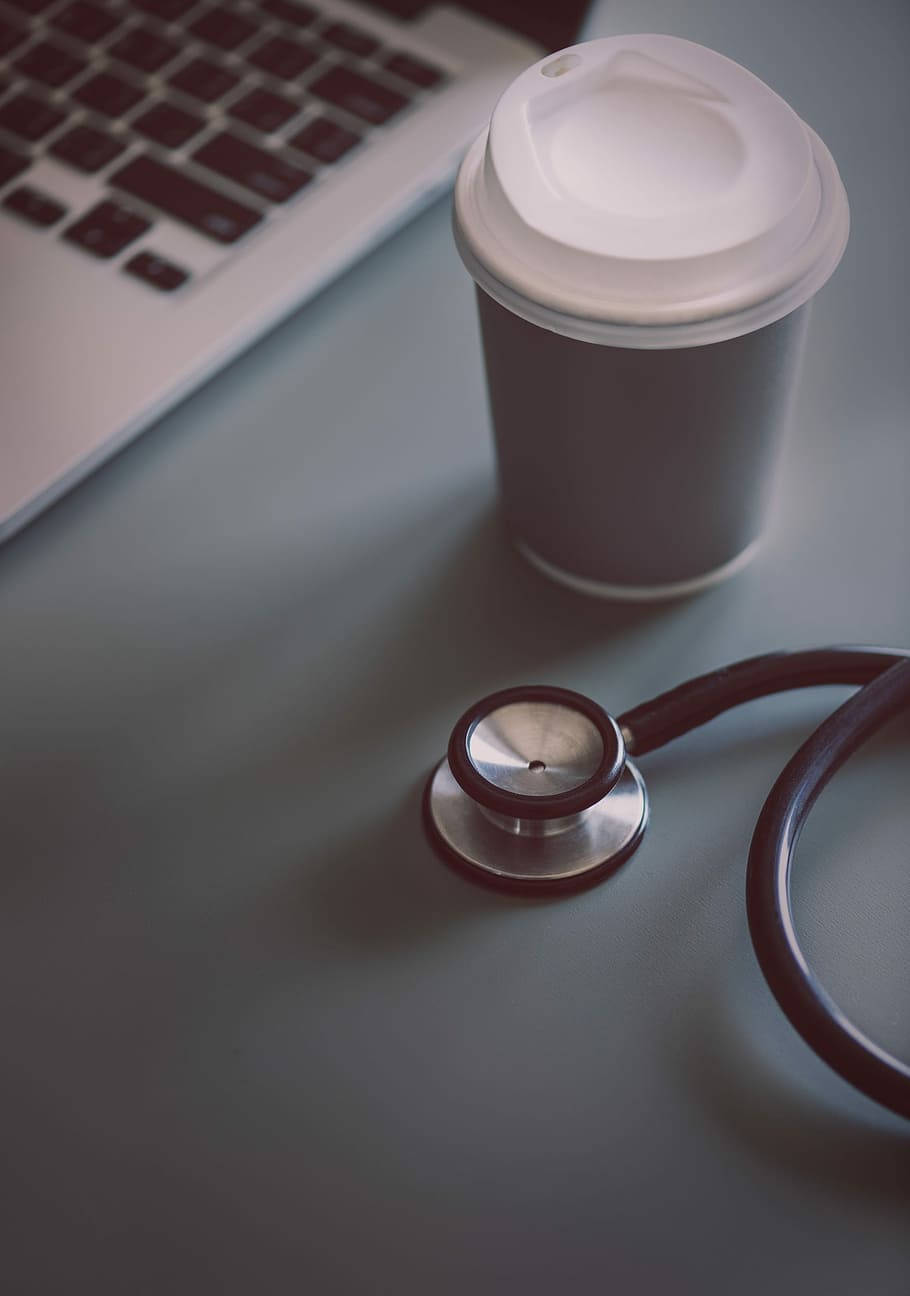 Stethoscope 桌布 壁紙 — 聽診器咖啡杯和筆記型電腦放在簡約工作空間的時尚灰色桌子上。