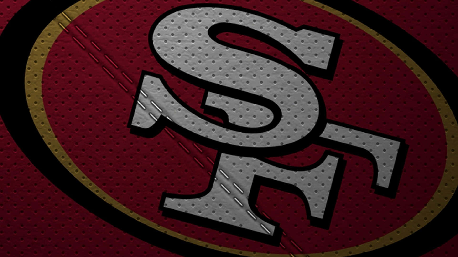 49ers 桌布 壁紙 — 舊金山49人隊標誌縫在帶有金色和黑色飾邊的紋理紅色美式足球球衣上。