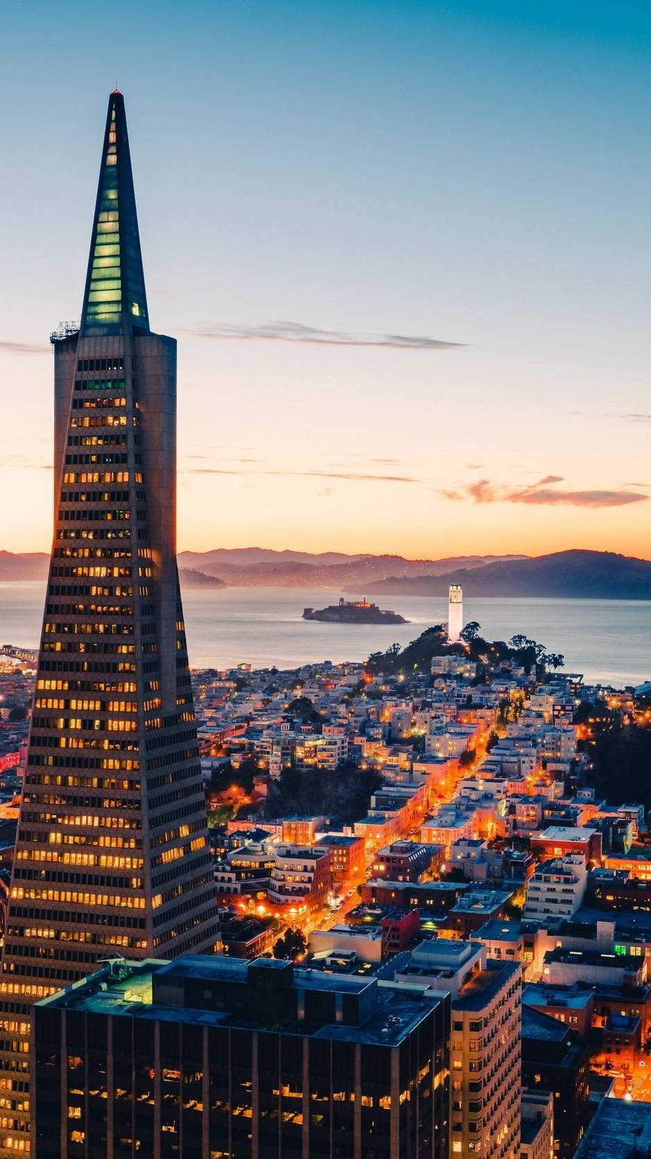 san francisco iPhone 桌布 壁紙 — 舊金山黃昏天際線，泛美金字塔在漸變色天空中閃耀，遠處可見金門大橋。