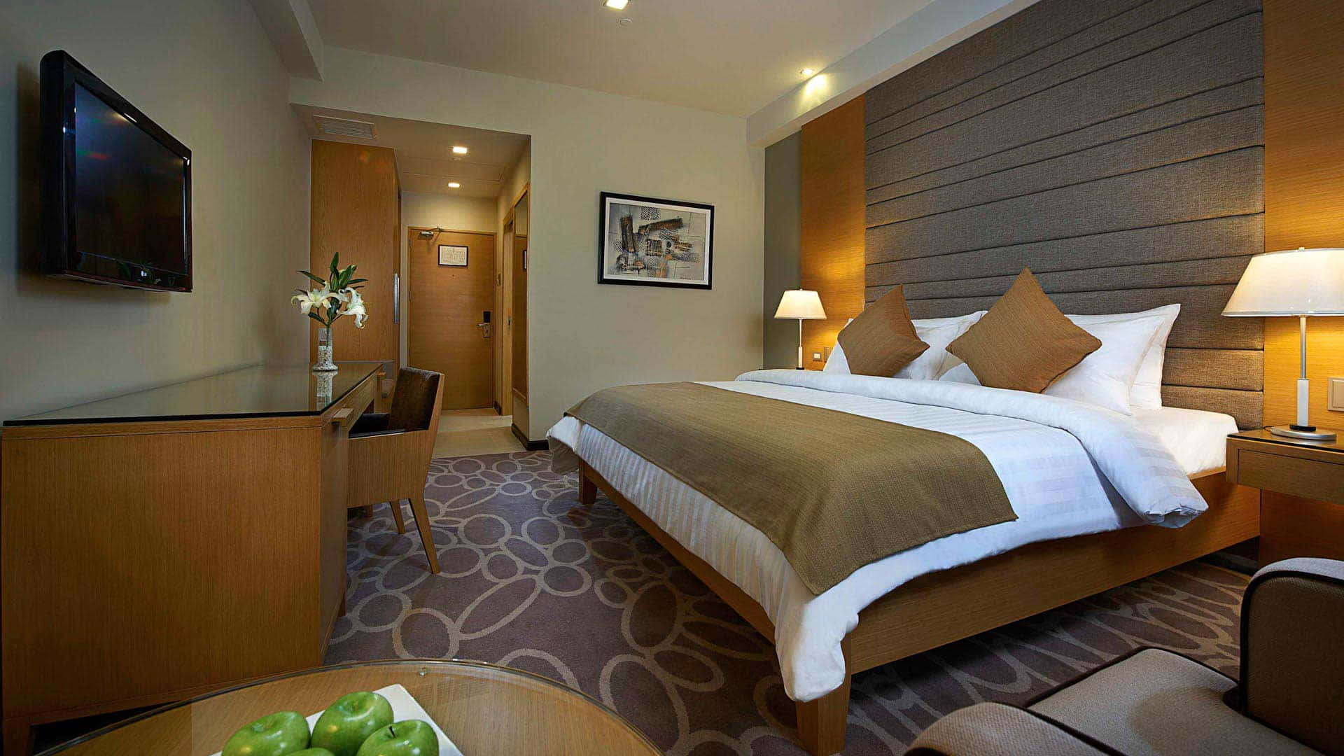 Bedroom 桌布 壁紙 — 舒適的飯店客房，配有整齊的床鋪、木製家具和床頭燈的溫暖照明。