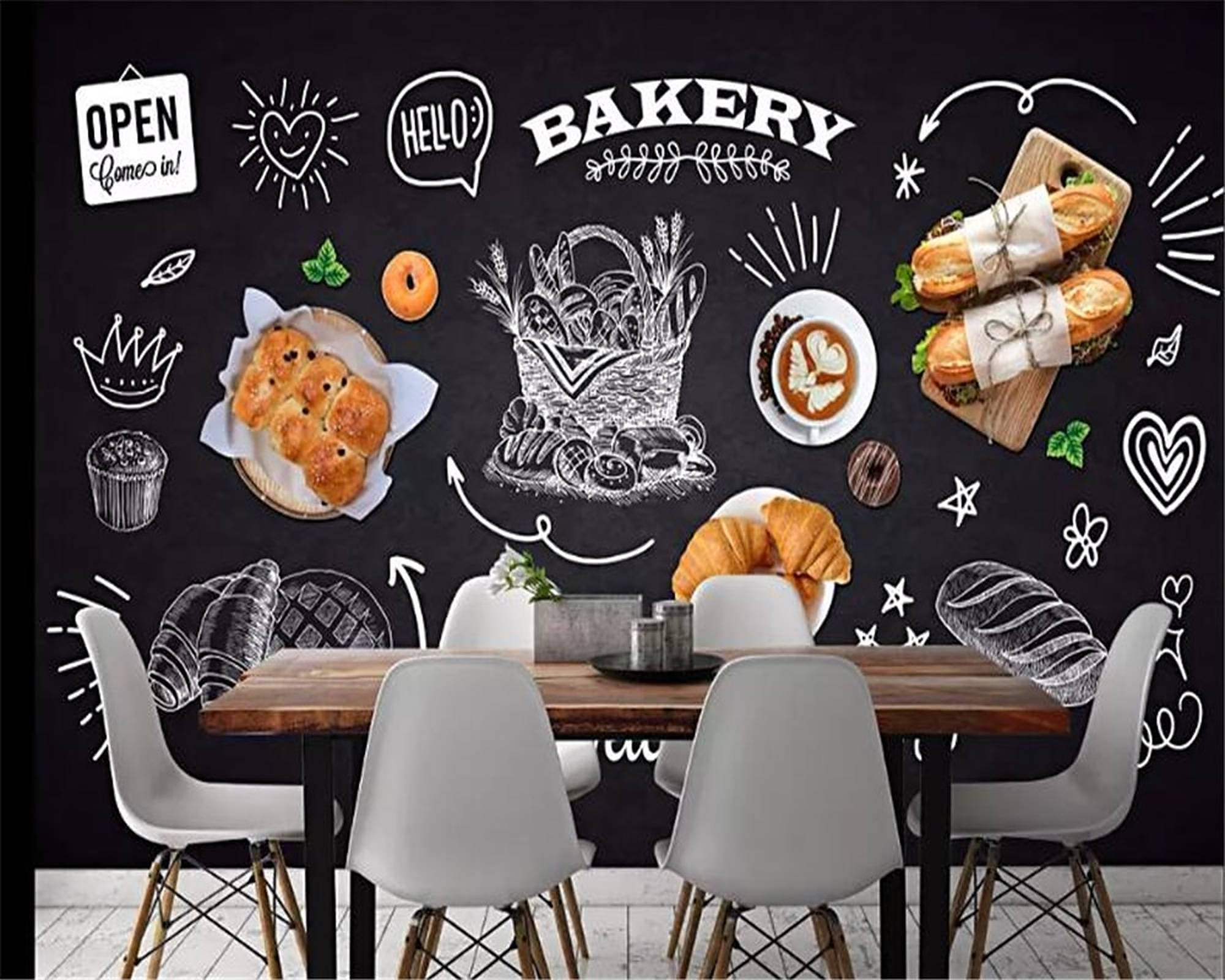 Bakery 桌布 壁紙 — 舒適的麵包店內部，黑板牆上繪有手繪糕點、咖啡和歡迎塗鴉，圍繞著一張木桌和白色椅子。