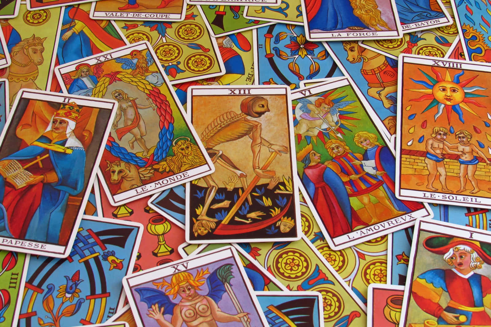 Tarot Card 桌布 壁紙 — 色彩繽紛的塔羅牌充滿活力而混亂地散開，描繪神話人物和象徵圖案。