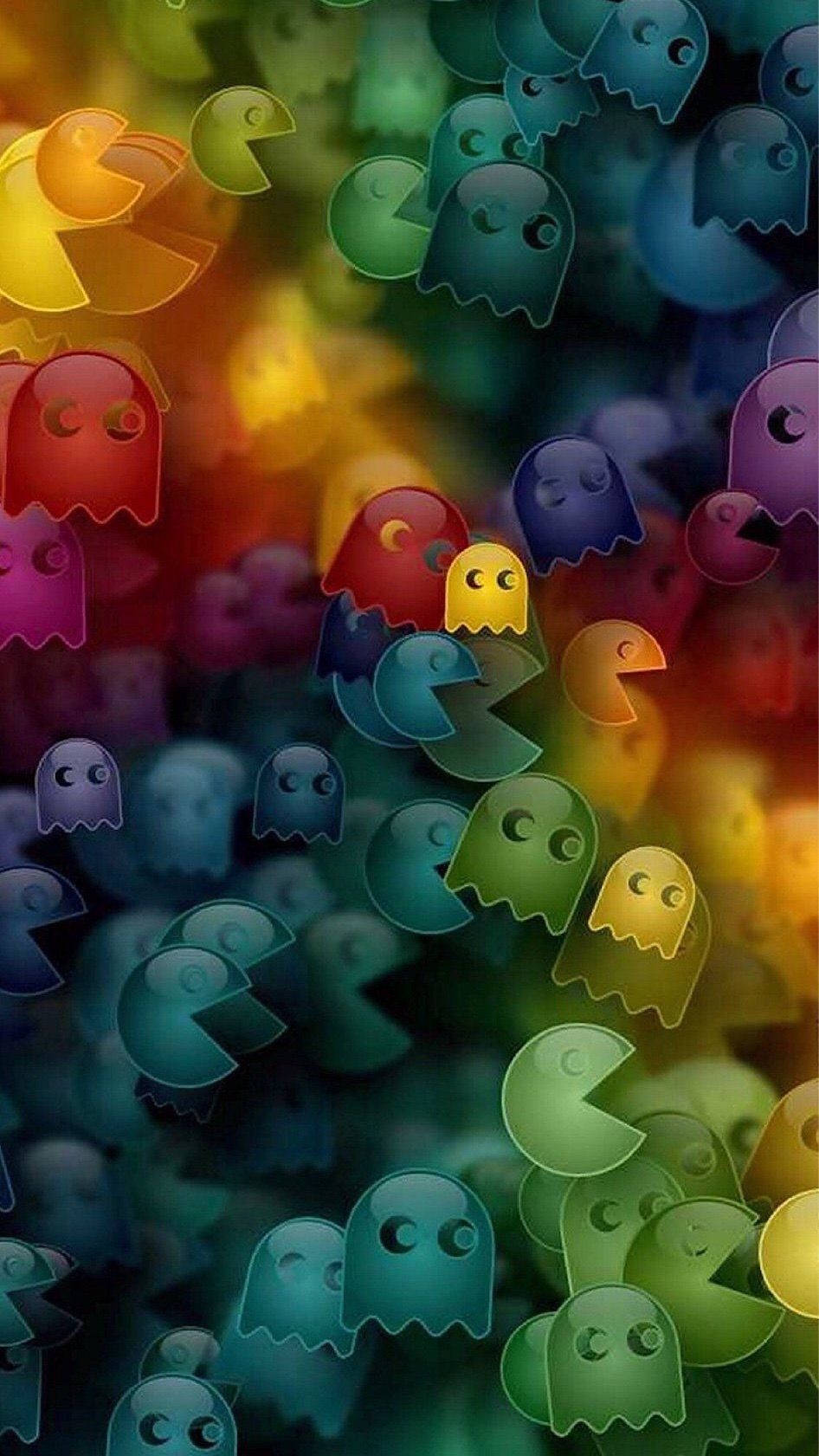 電玩遊戲 桌布 壁紙 — 色彩繽紛的彩虹色 Pac-Man 鬼魂漂浮在帶有柔和散景效果的發光模糊背景中。