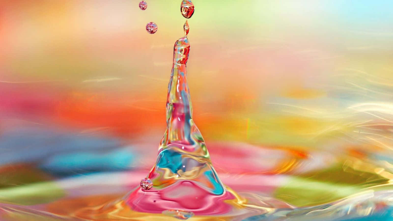 Water Drops 桌布 壁紙 — 色彩繽紛的模糊背景下，水滴在空中凝固的充滿活力的飛濺。