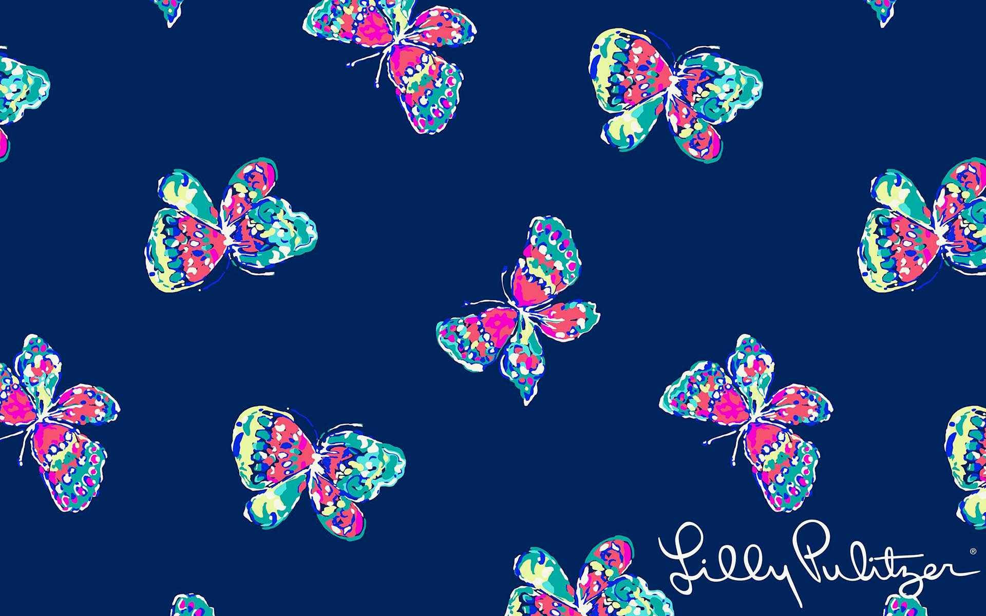 lilly 桌布 壁紙 — 色彩繽紛的蝴蝶帶有圖案翅膀，在深海軍藍背景上以重複設計漂浮。