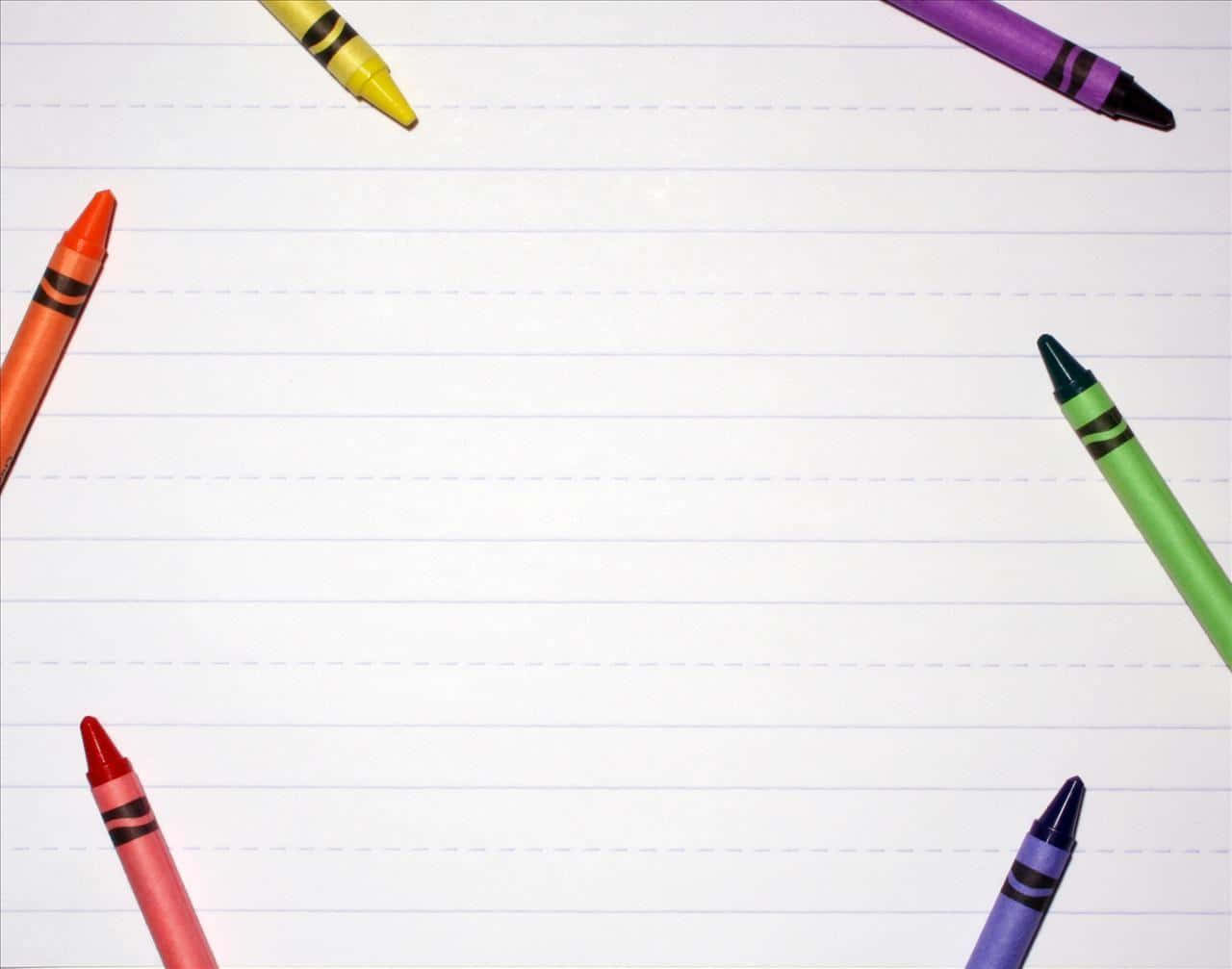 crayon 桌布 壁紙 — 色彩繽紛的蠟筆排列在橫線筆記本紙張的邊框上，營造出創意寫作提示。