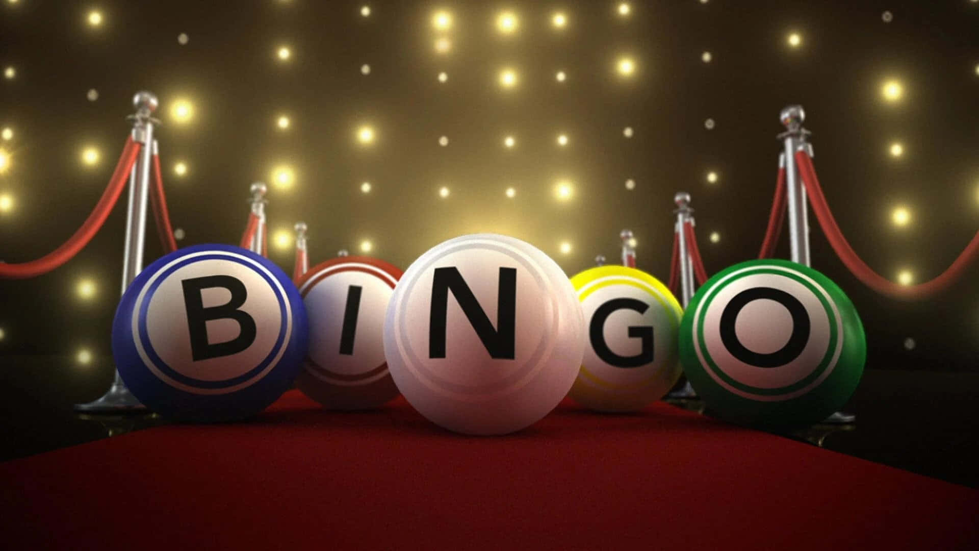 Bingo 桌布 壁紙 — 色彩繽紛的賓果球拼出「bingo」字樣，放置在紅地毯上，兩旁有欄杆，上方閃爍著燈光。
