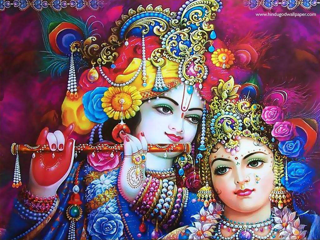 krishna ji 桌布 壁紙 — 色彩鮮豔的印度教神祇克里希納和拉達，飾以華麗珠寶和彩色花冠，背景為濃郁的洋紅色。