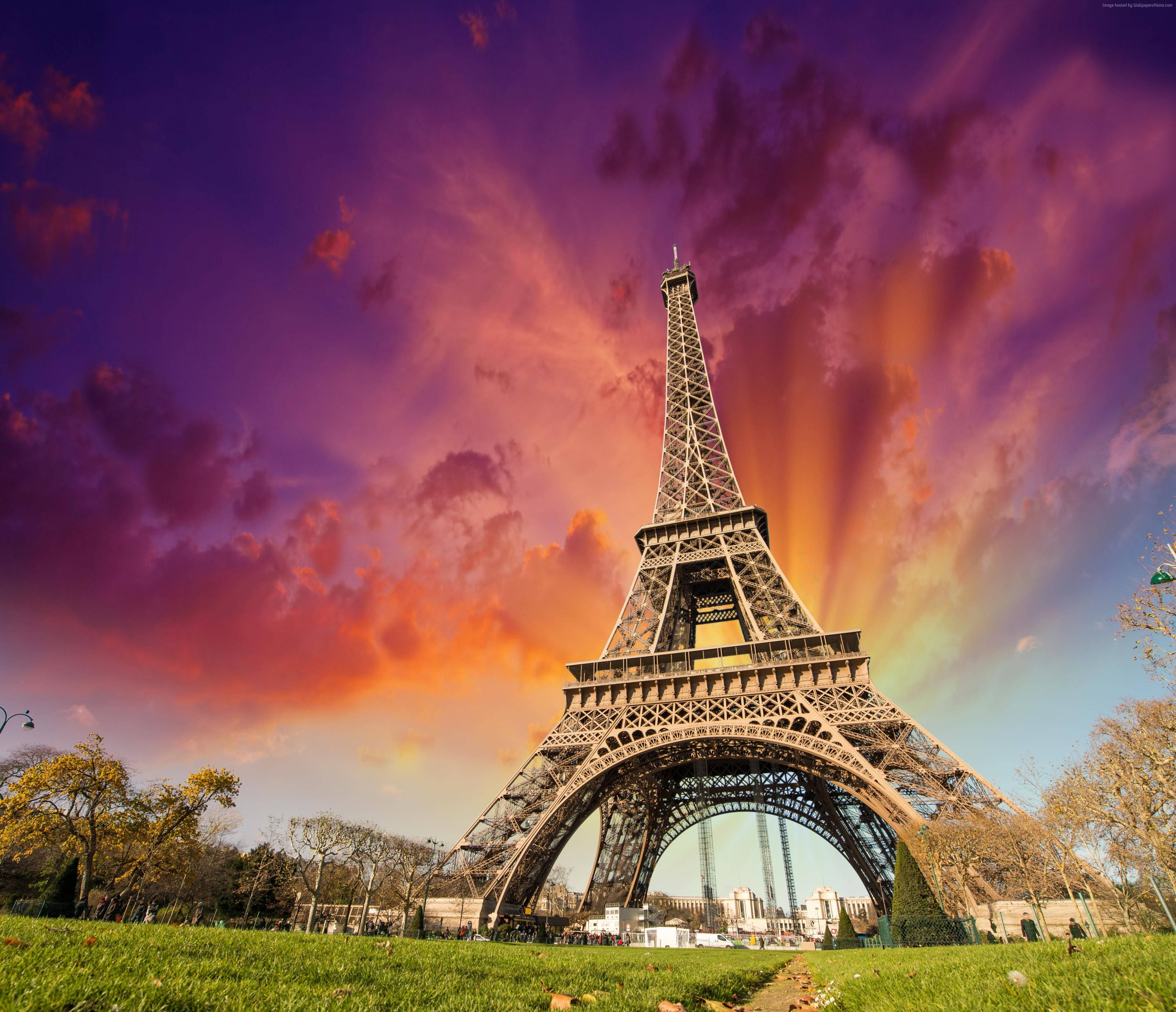 Beautiful Scenery Desktop 桌布 壁紙 — 艾菲爾鐵塔在充滿活力的紫色和橙色日落天空與戲劇性的雲層中高高聳立。