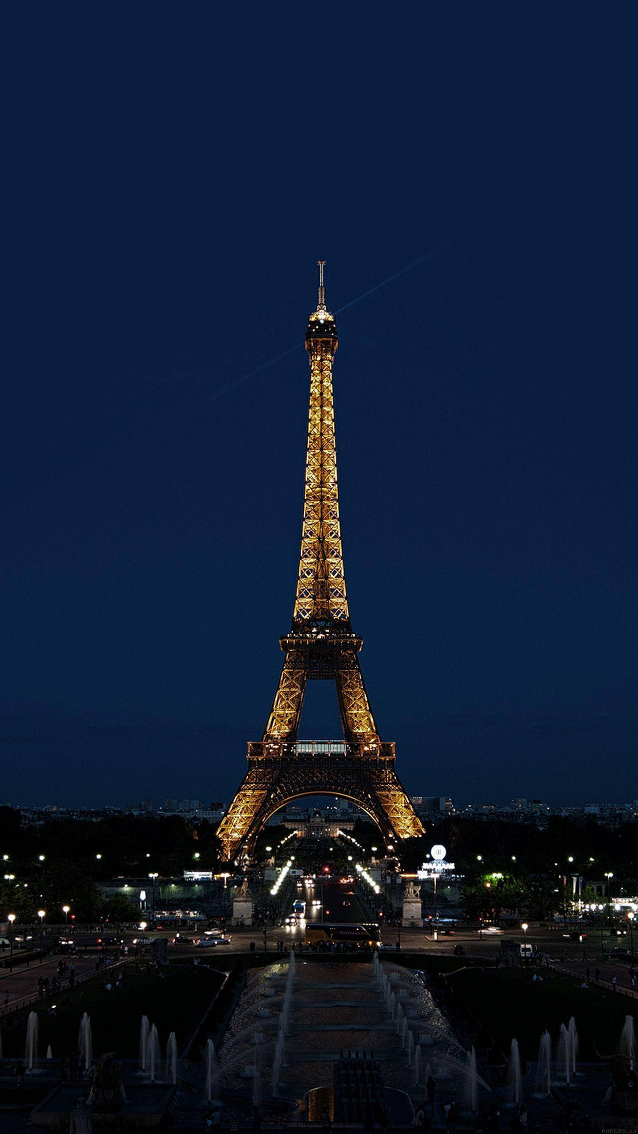 Paris Eiffel Tower 桌布 壁紙 — 艾菲爾鐵塔在深藍色夜空下溫暖發光，下方有噴泉和城市燈光。