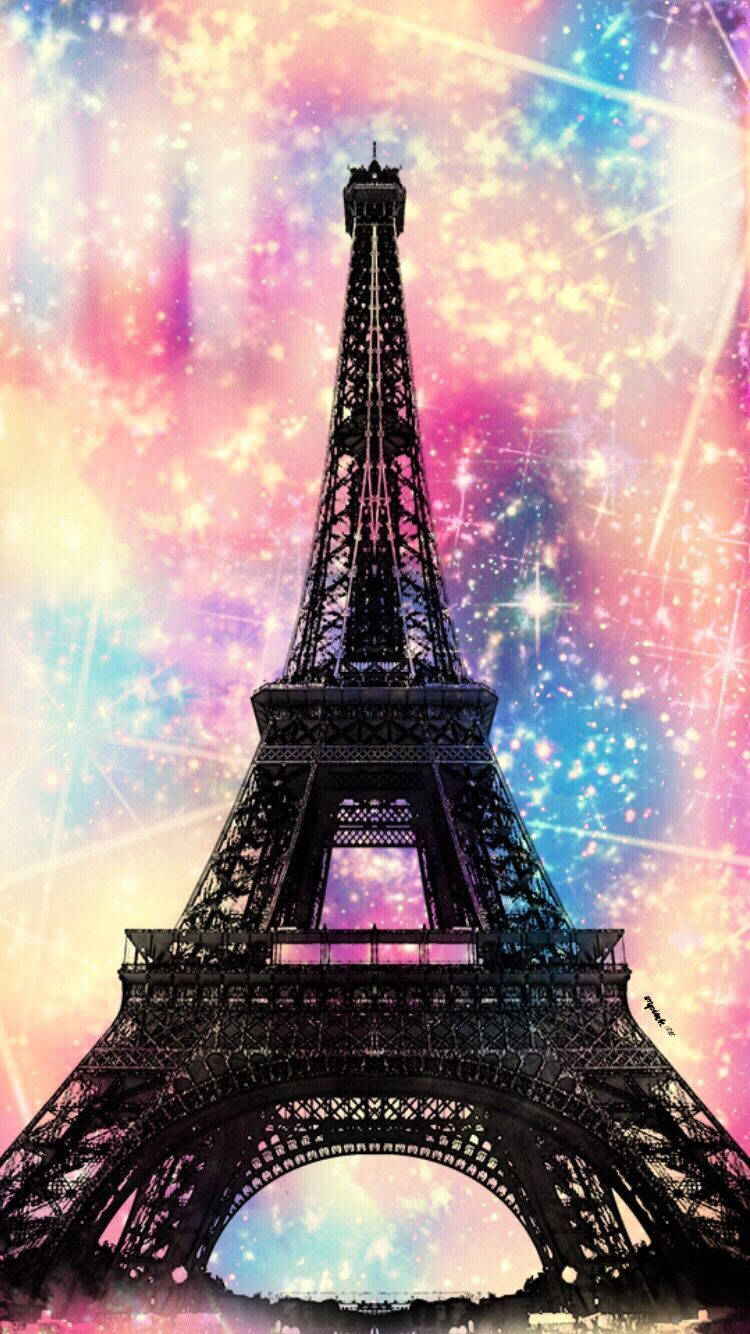 Eiffel Tower 桌布 壁紙 — 艾菲爾鐵塔的剪影在充滿閃爍星星和絢麗柔和色彩的鮮豔宇宙天空中巍然聳立。