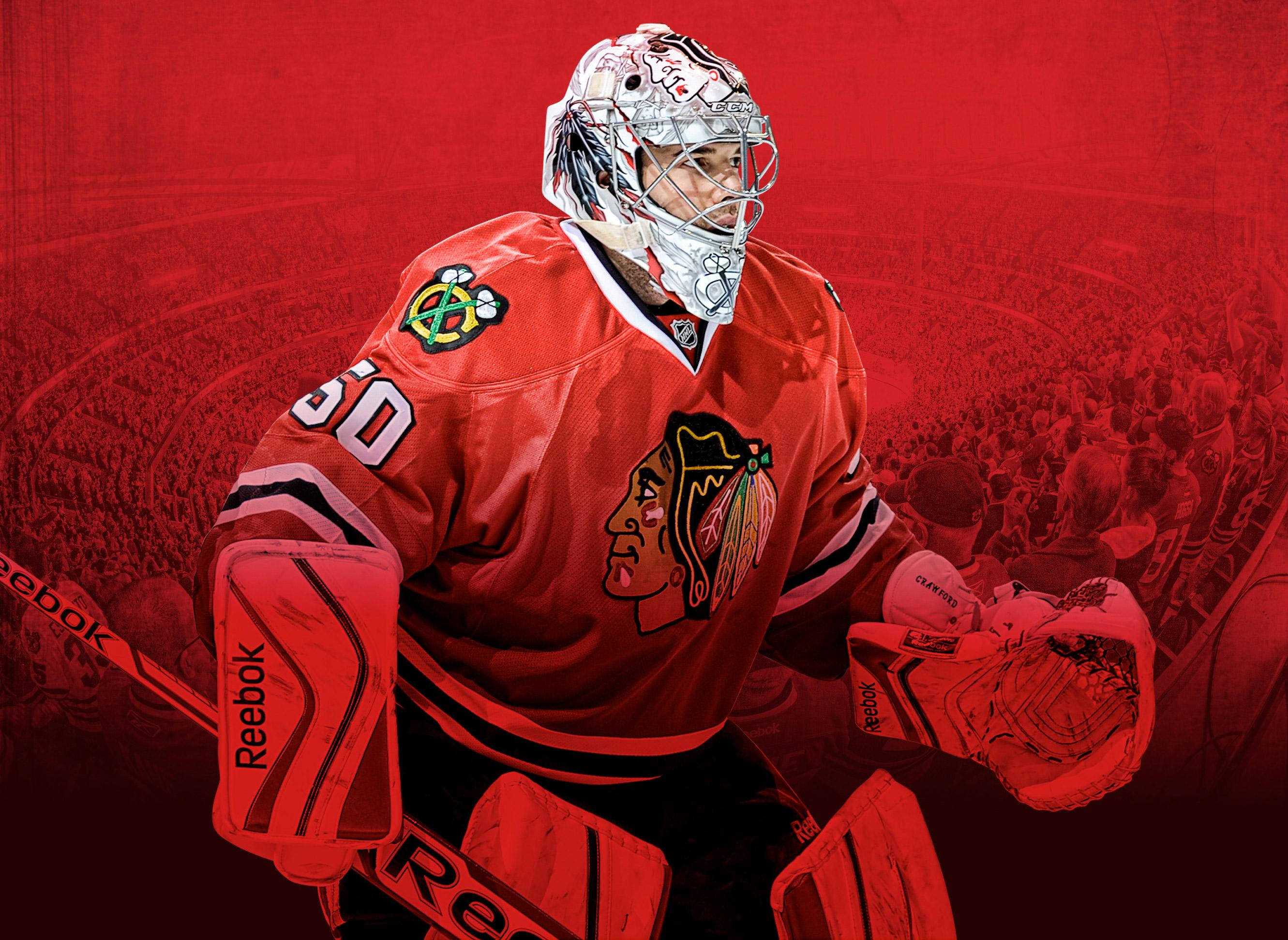 Blackhawks 桌布 壁紙 — 芝加哥黑鷹隊冰球守門員身穿紅色裝備，戴著手套和拿著球棍，準備就緒，背景是模糊的人群。