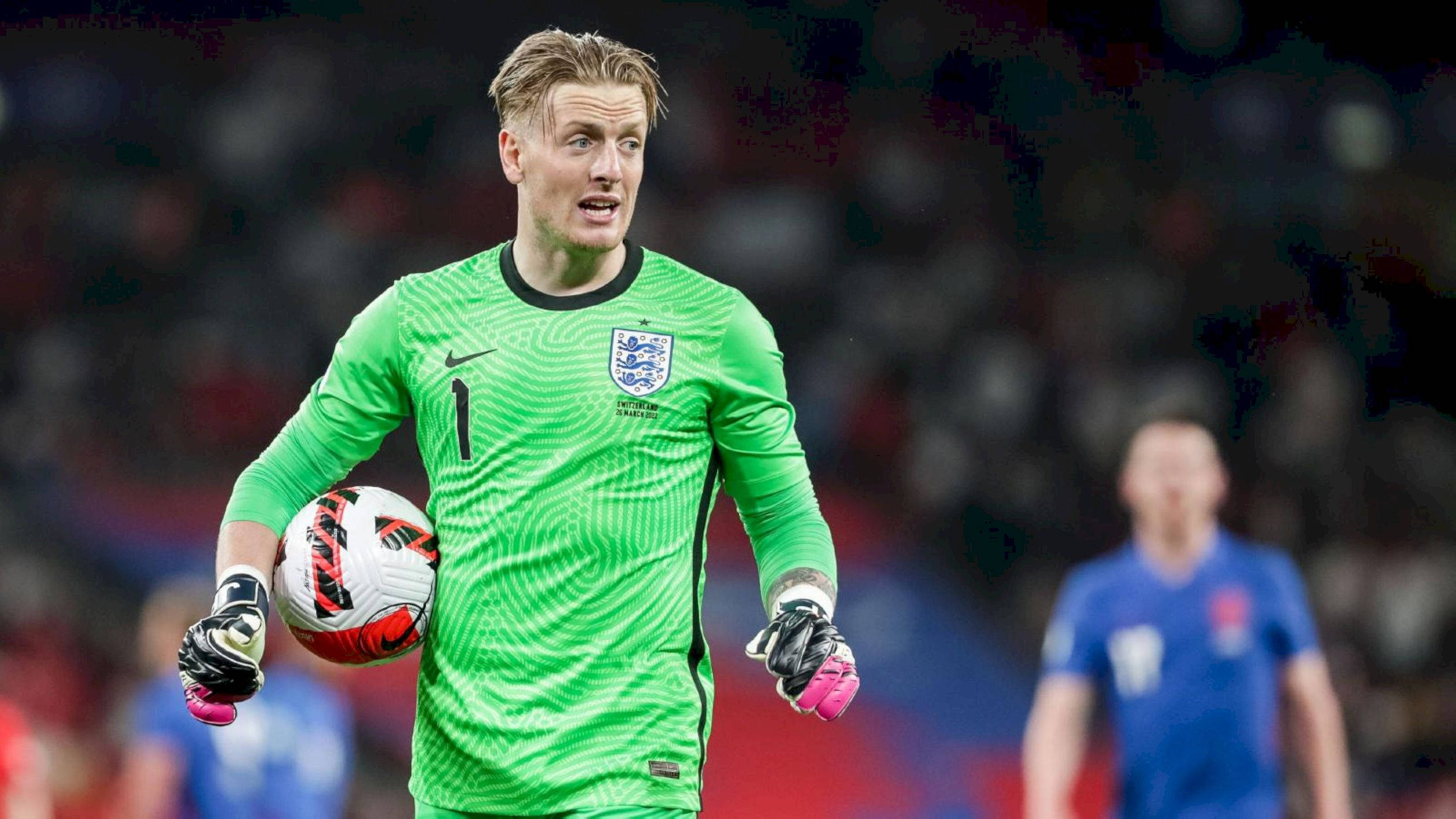 Football Players 桌布 壁紙 — 英格蘭的綠色球衣守門員在模糊的球場上拿著足球邁步。