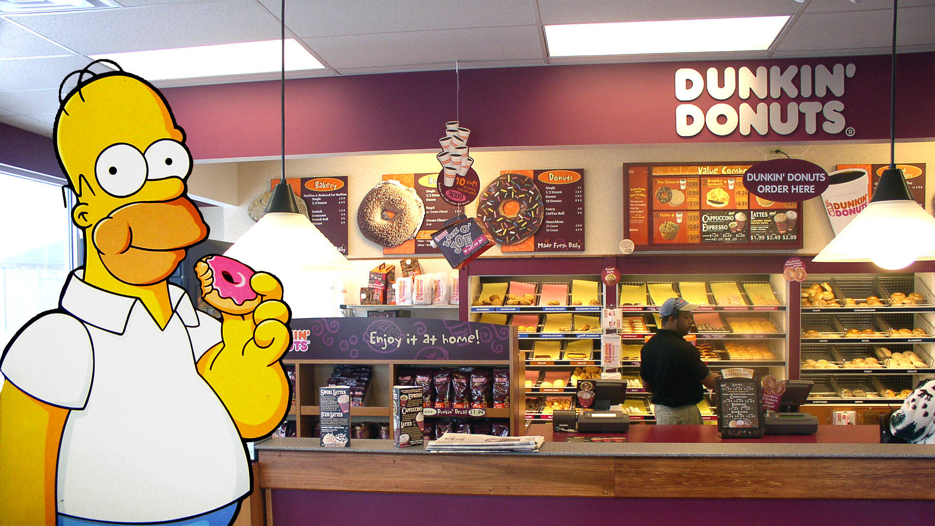 donuts 桌布 壁紙 — 荷馬·辛普森卡通角色在真實的Dunkin' Donuts烘焙櫃檯前拿著一個粉紅色糖霜甜甜圈。